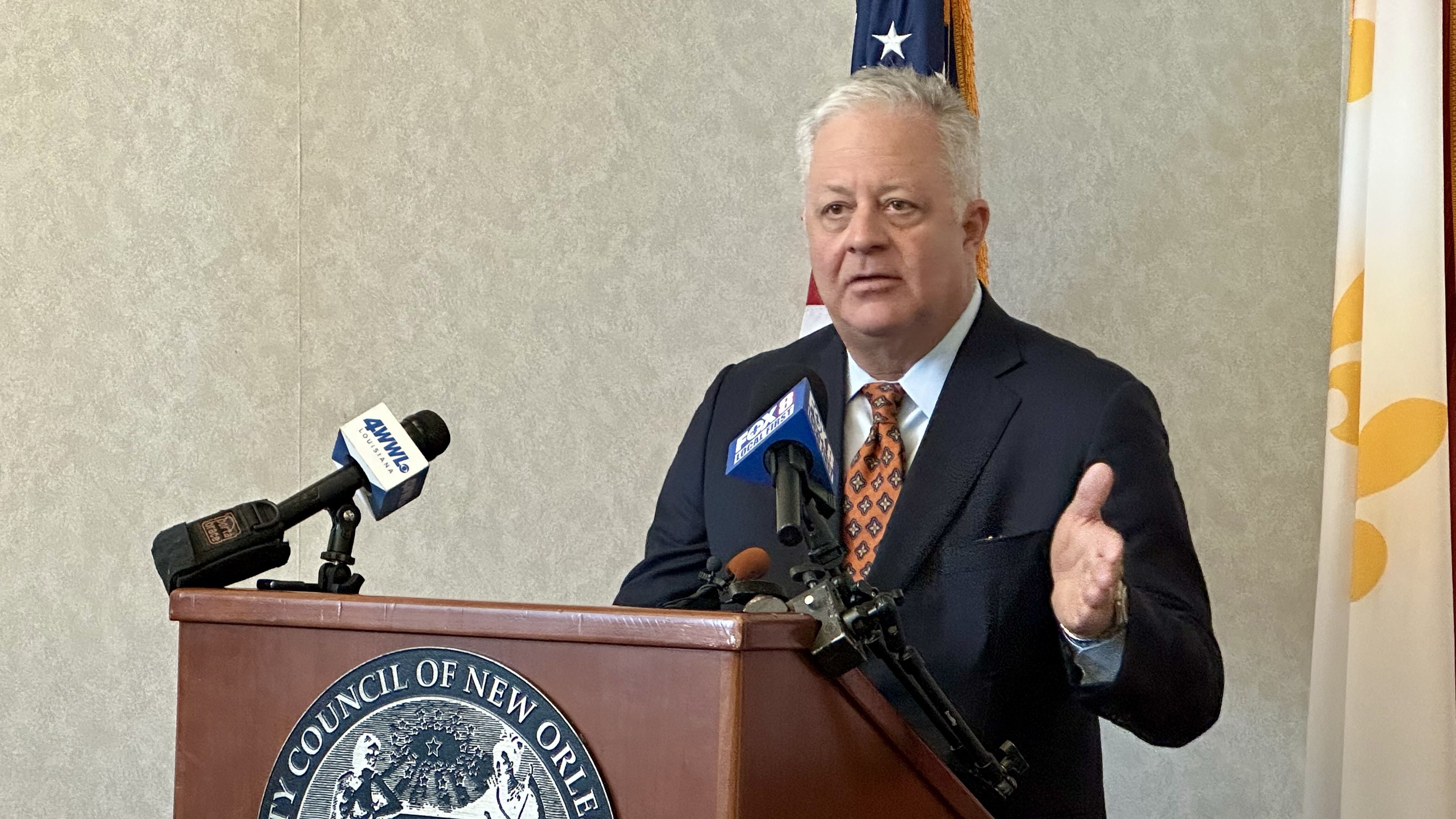 Image shows Mike Waguespack behind a podium.