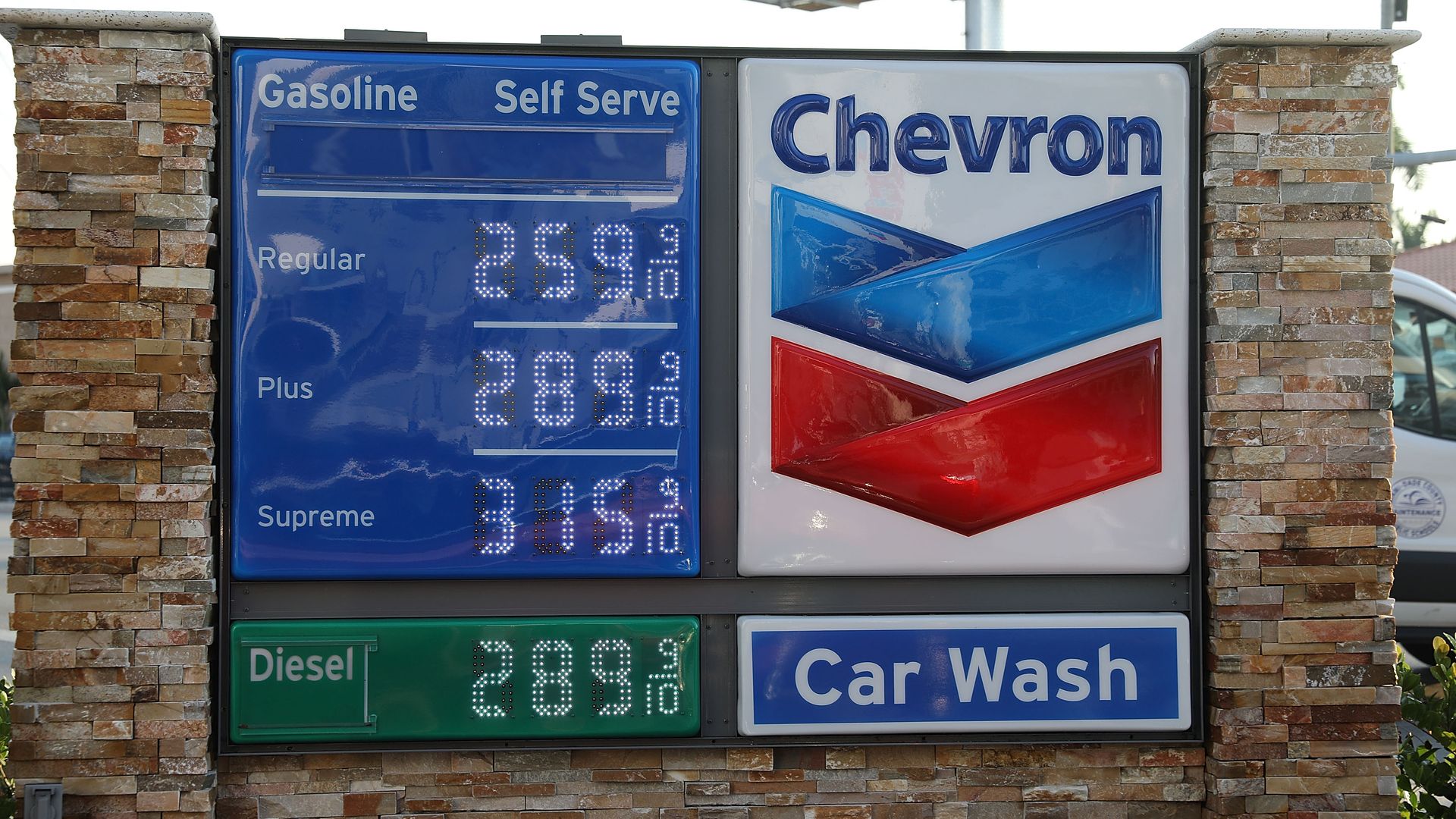 A sign displaying the price of gasoline per gallon is seen at a Chevron gas station