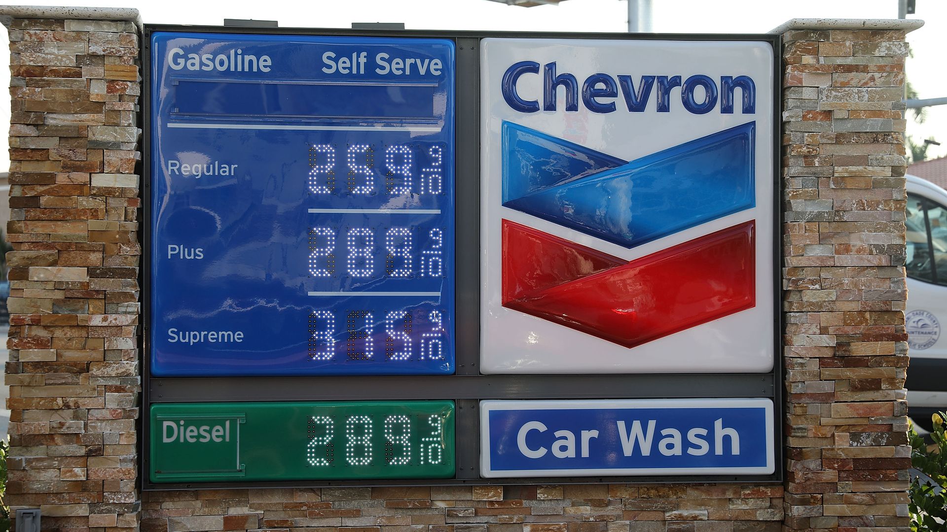 A sign displaying the price of gasoline per gallon is seen at a Chevron gas station