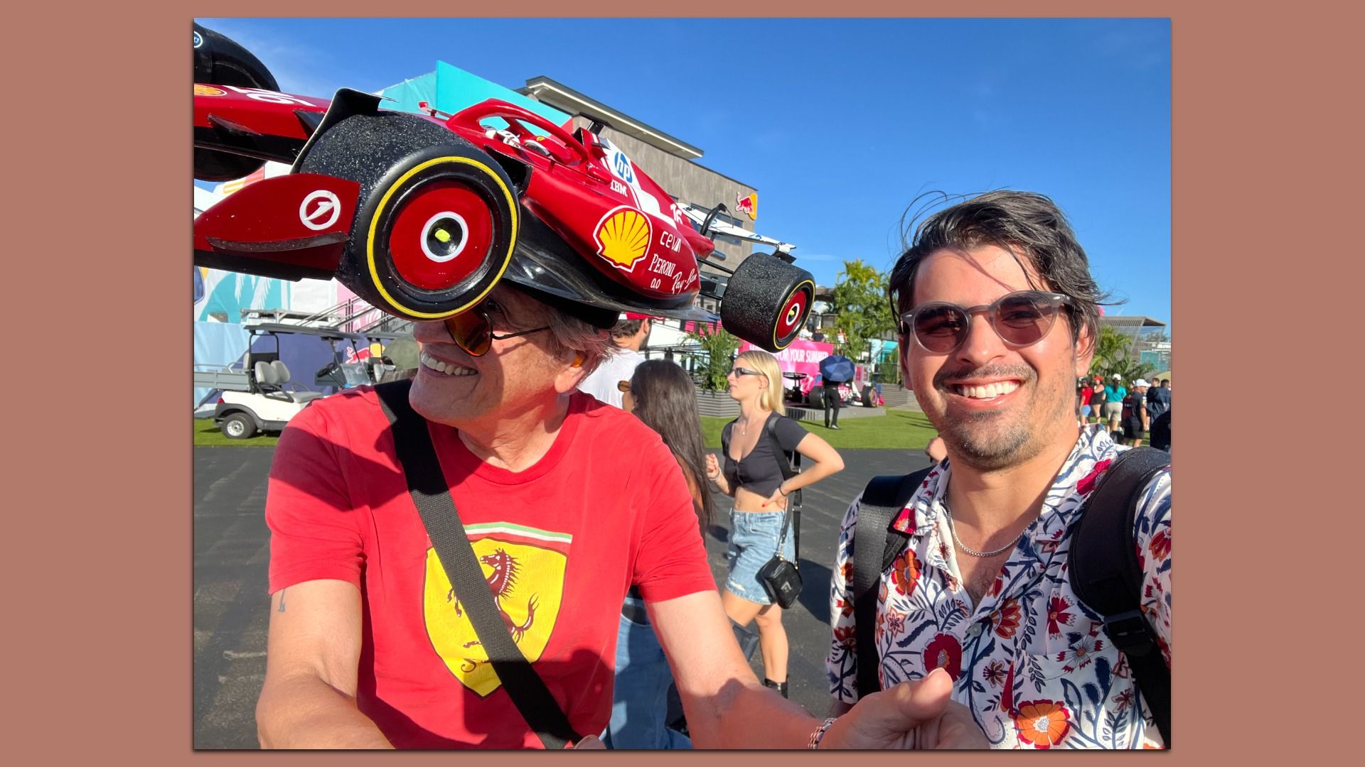 Martin poses with a Ferrari fan wearing a Formula 1 car hat