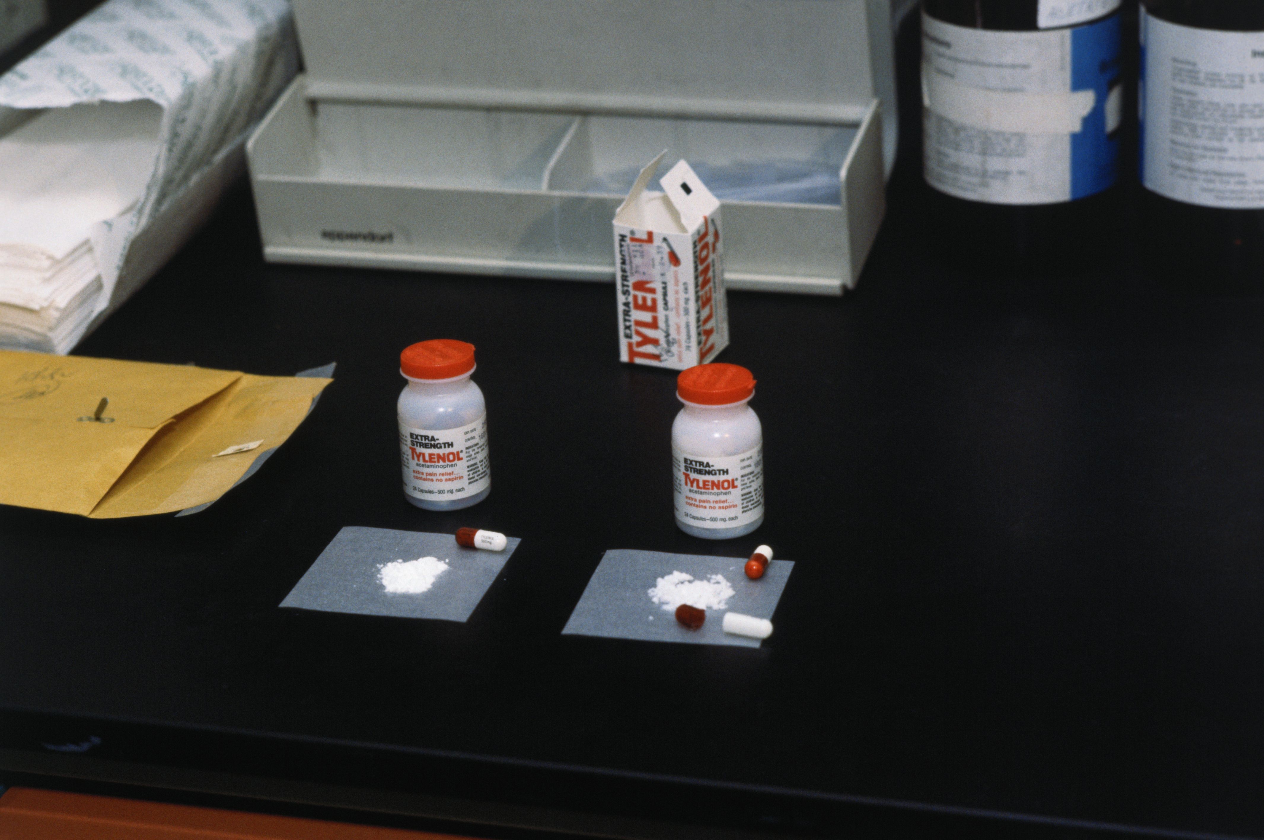 Photo of tylenol pills and powder on a table. 