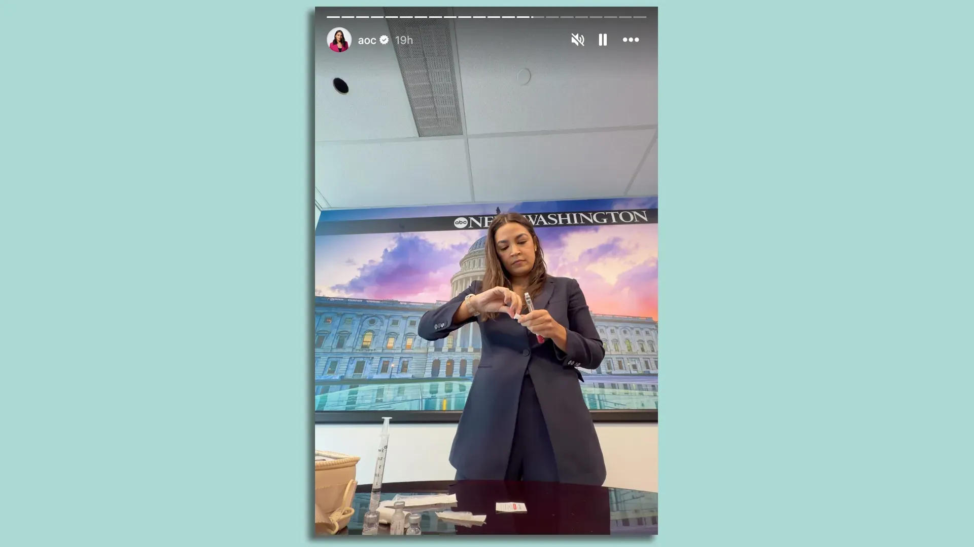 Rep. Alexandria Ocasio-Cortez (D-N.Y.) prepares an injection before appearing on ABC's "This Week" on Sunday. Screenshot: @aoc via Instagram