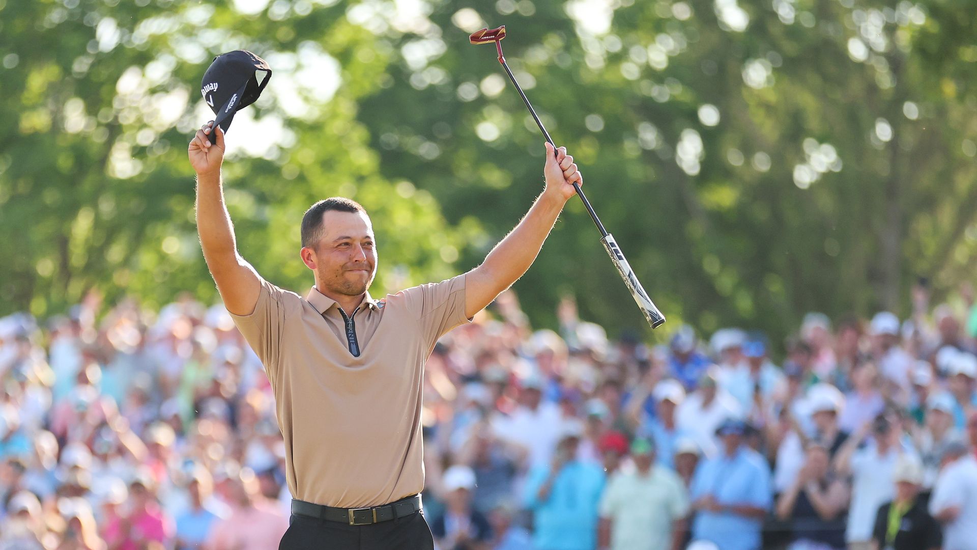 A male golfer celebrates. 