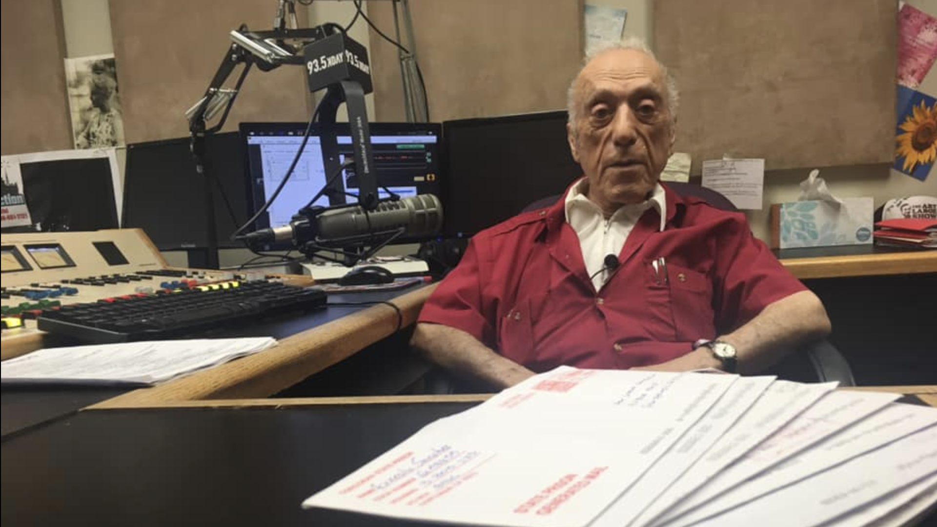 DJ Art Laboe sits behind a stack of letters from inmates seeking dedications on his show.