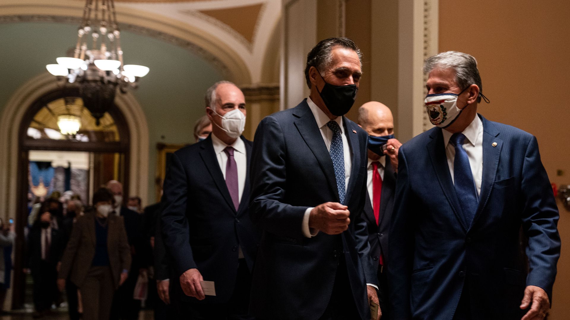 Photo of Sens. Mitt Romney (R-UT) and Sen. Joe Manchin (D-WV) walking together from the Senate Chamber to the House Chamber