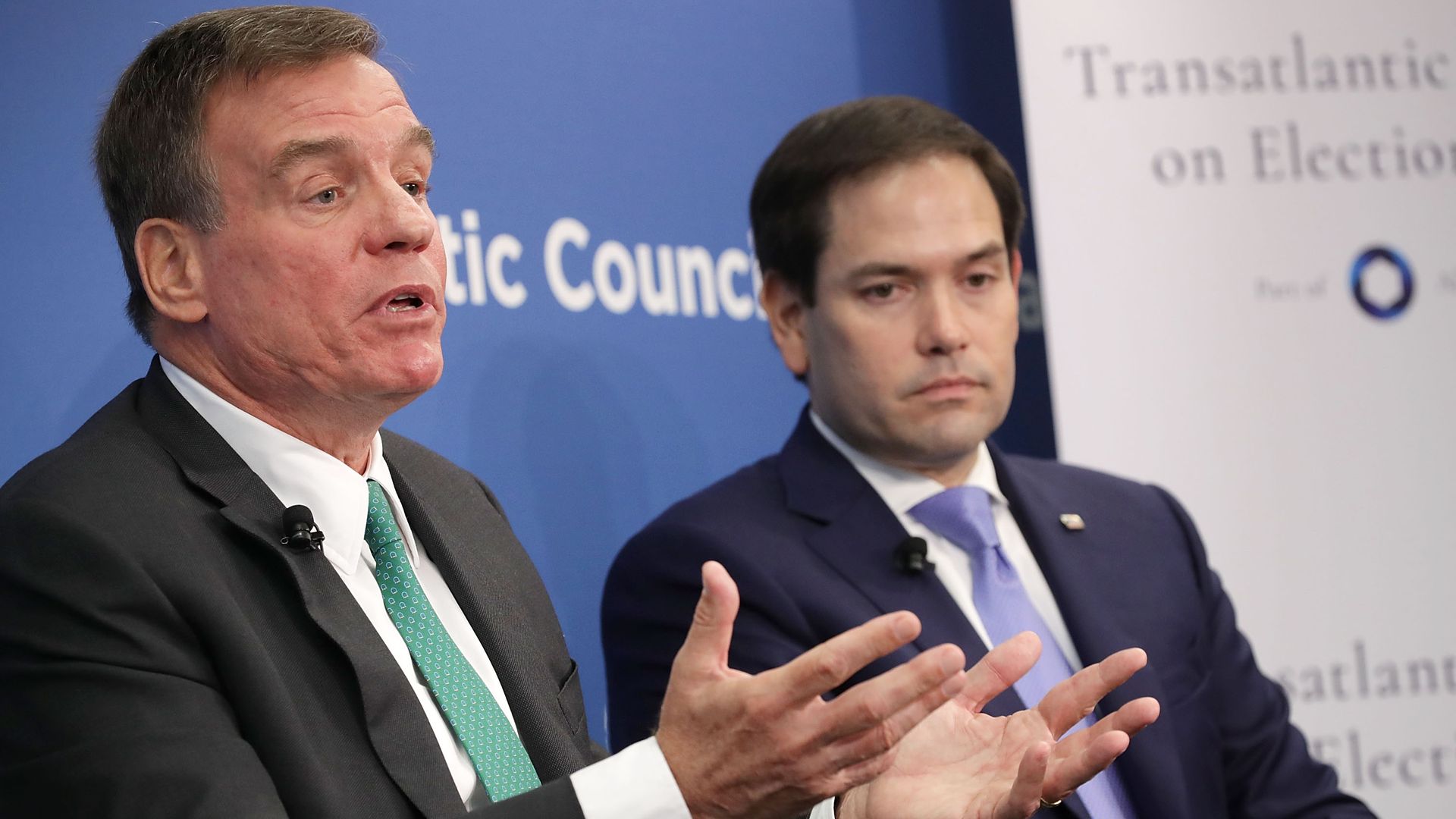 Sen. Mark Warner (D-VA) (L) and Sen. Marco Rubio (R-FL), both members of the Senate Intelligence Committee, participate in a discussion at the Atlantic Council July 16, 2018 in Washington, DC. 