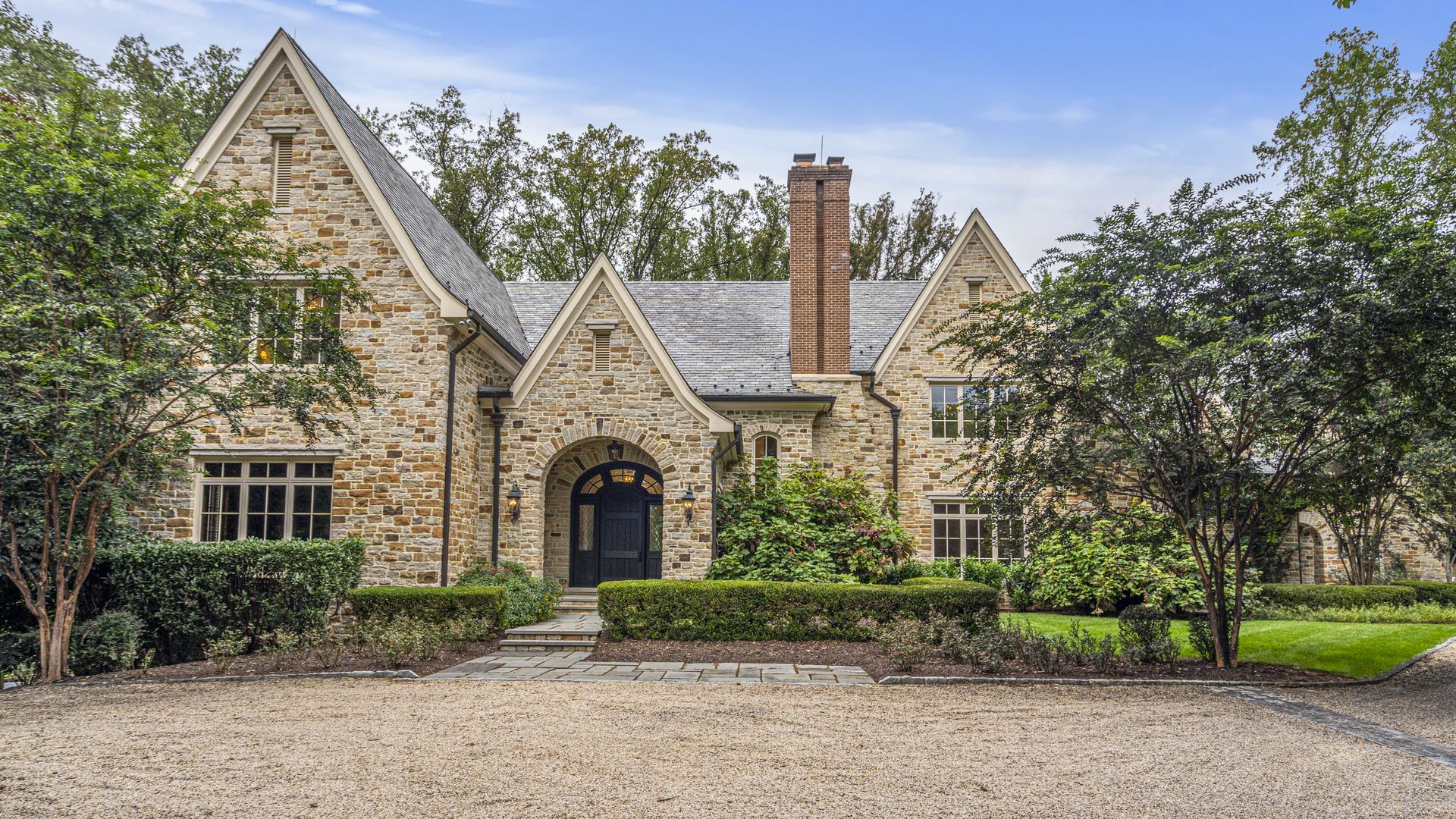 The exterior of a stone house with a vaulted roof.