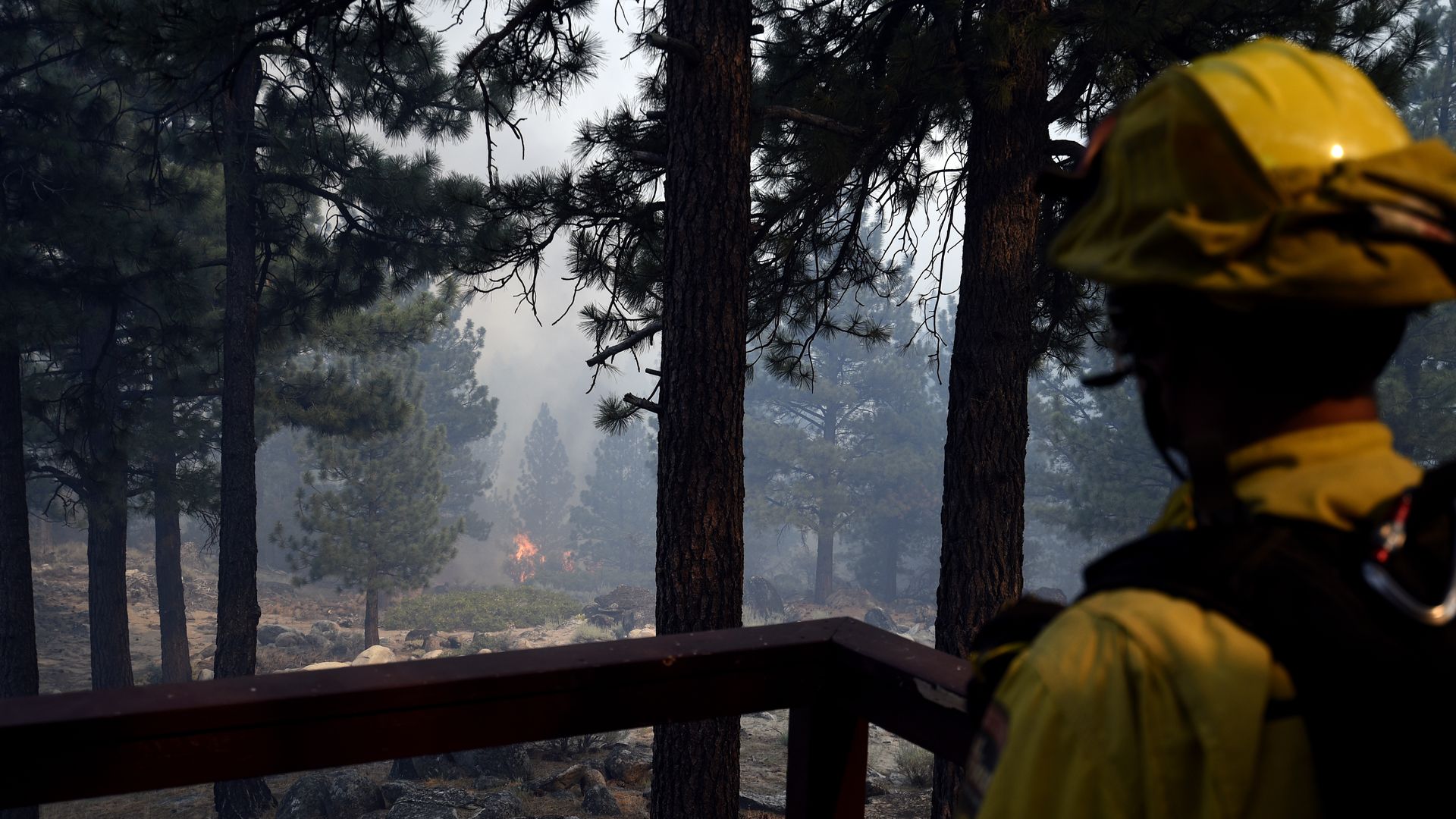 Firefighters take measures at the site as fire continues in Doyle, California, United States on July 12