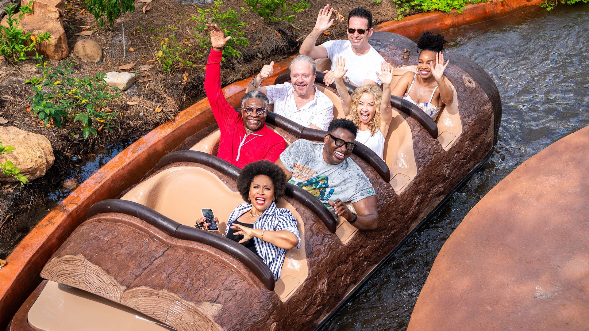 Photo shows the voice actors of "The Princess and the Frog" riding Tiana's Bayou Adventure at Disney World.