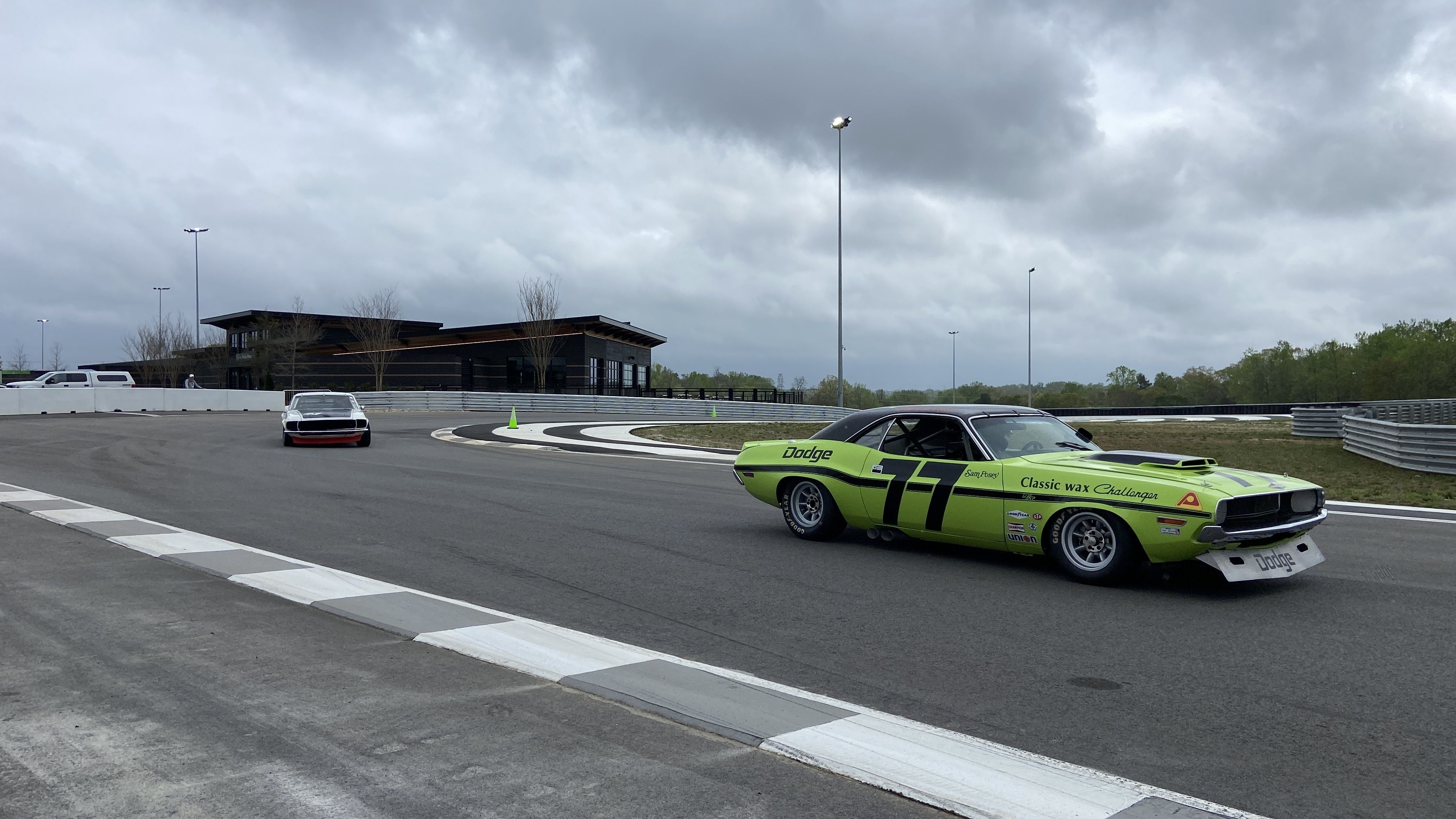 Vintage cars speed around the Ten Tenths Circuit. Photo: Ashley Mahoney/Axios