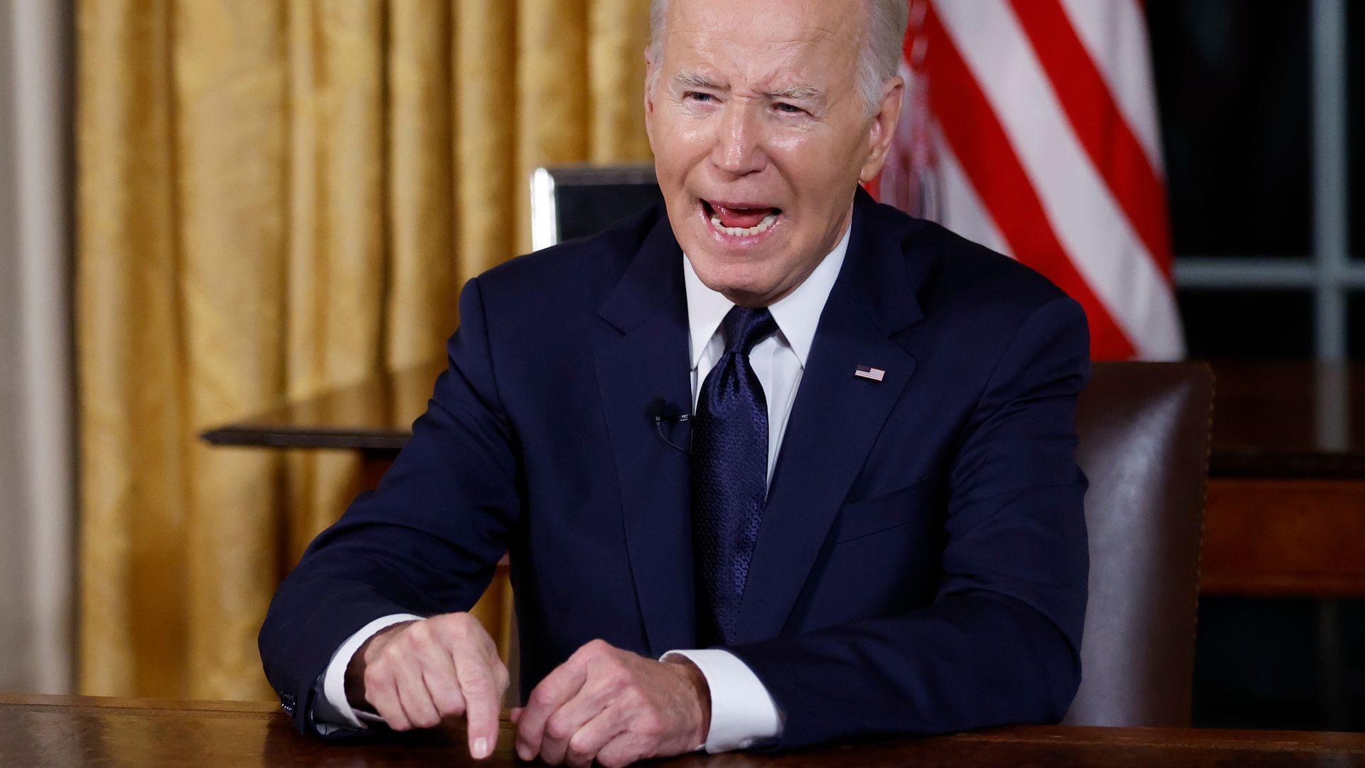 Biden gesticulates while speaking from the Oval Office