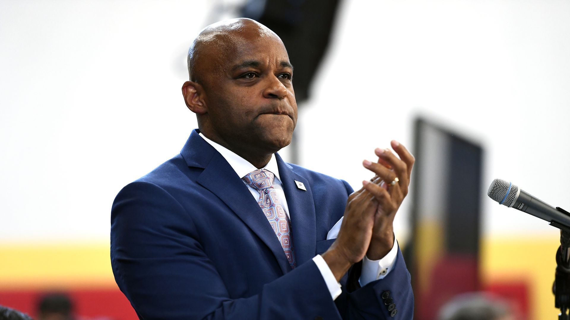 Denver Mayor Michael Hancock stands up clapping