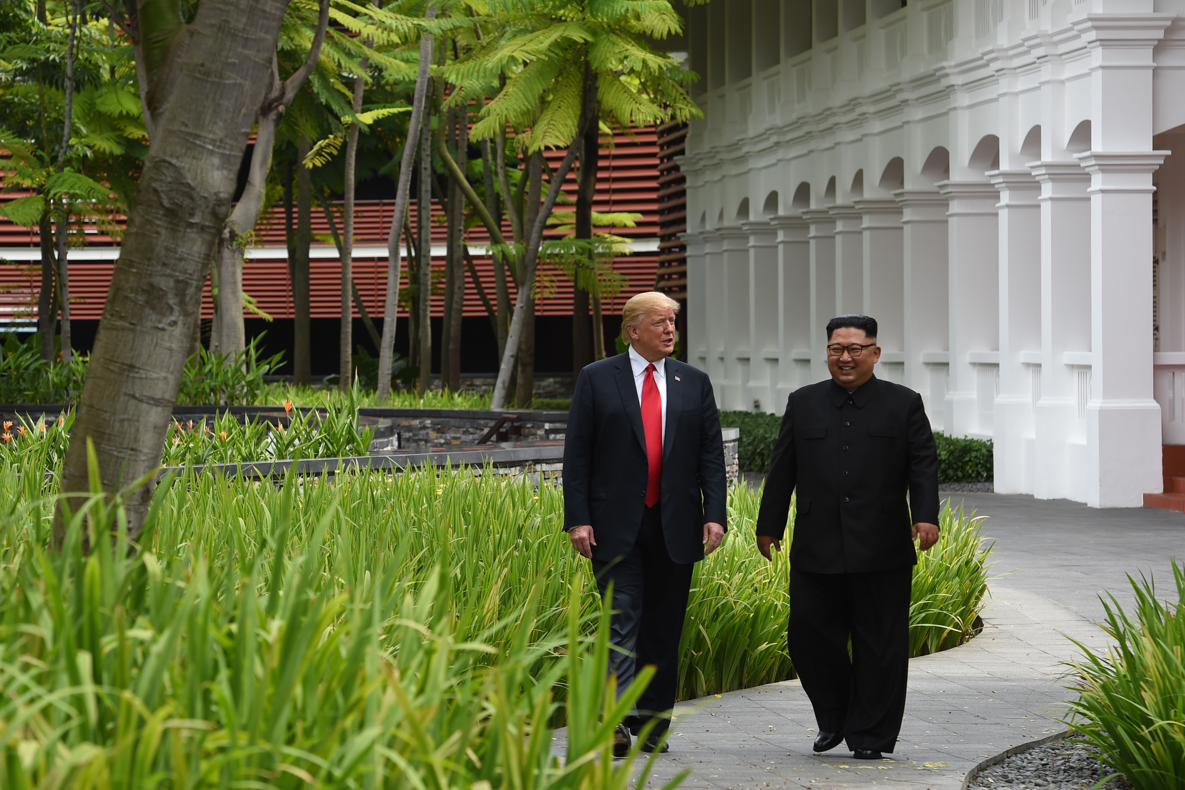 Trump and Kim stroll side by side through the resort