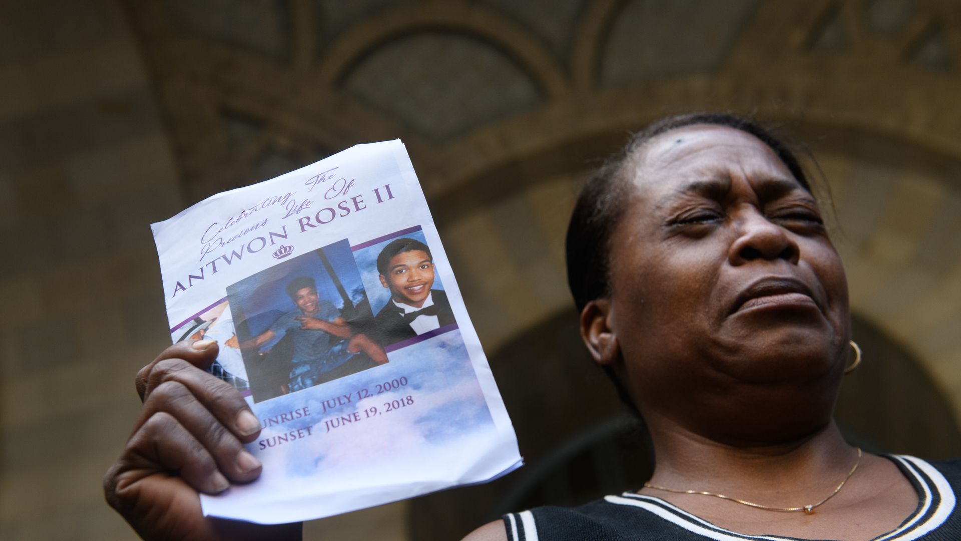  Carmen Ashley, the great aunt of Antwon Rose II, cries as she holds the memorial card from Rose's funeral in this file photo.