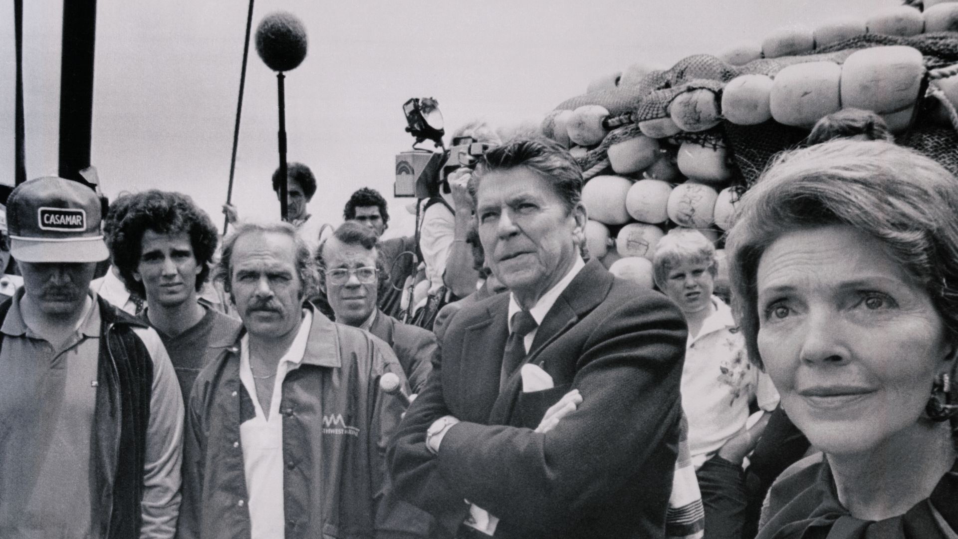 Historical photo of Ronald Reagan listening to local voters at a campaign event.