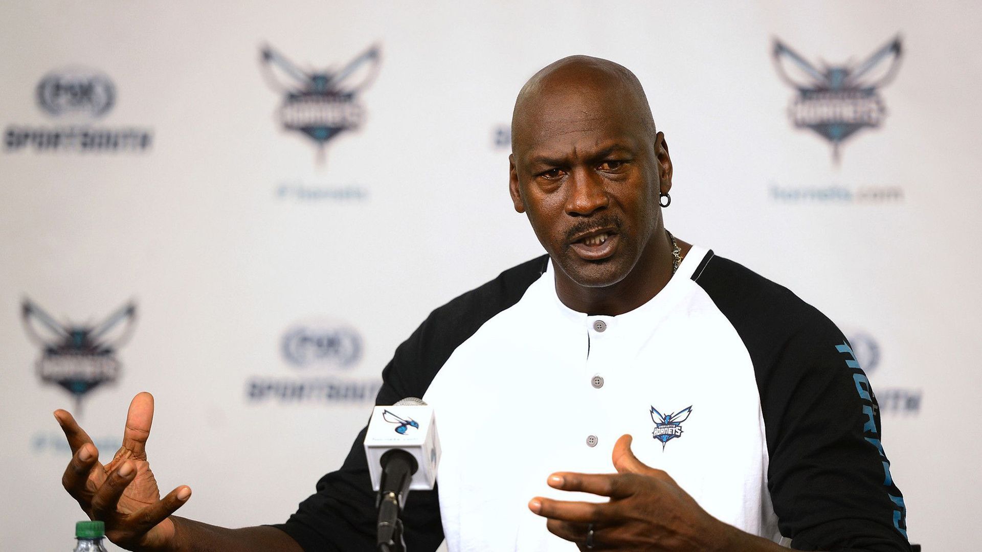 Michael Jordan speaking at a press conference.