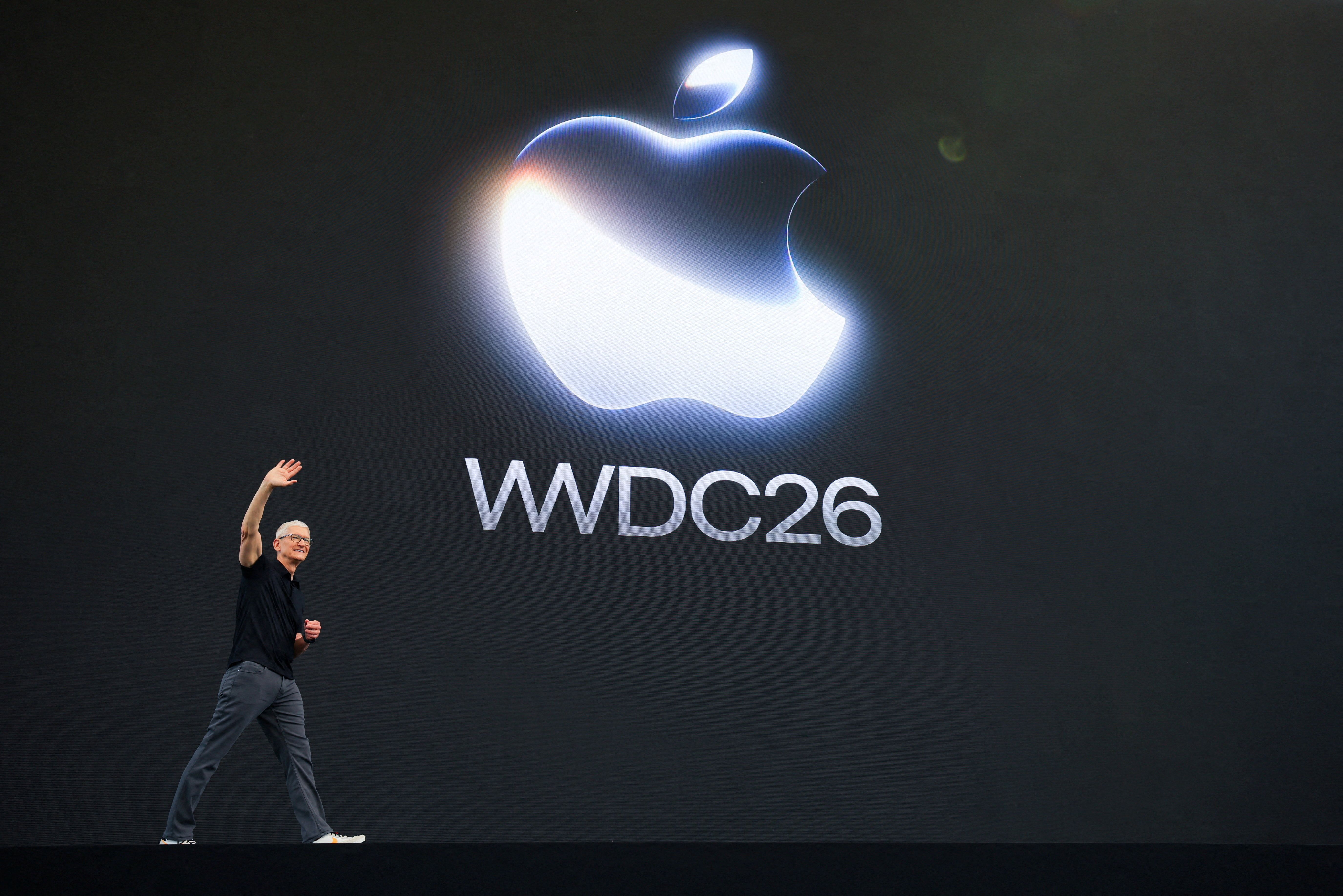 Apple CEO Tim Cook waves on stage during Apple's annual Worldwide Developers Conference yesterday in Cupertino, Calif.