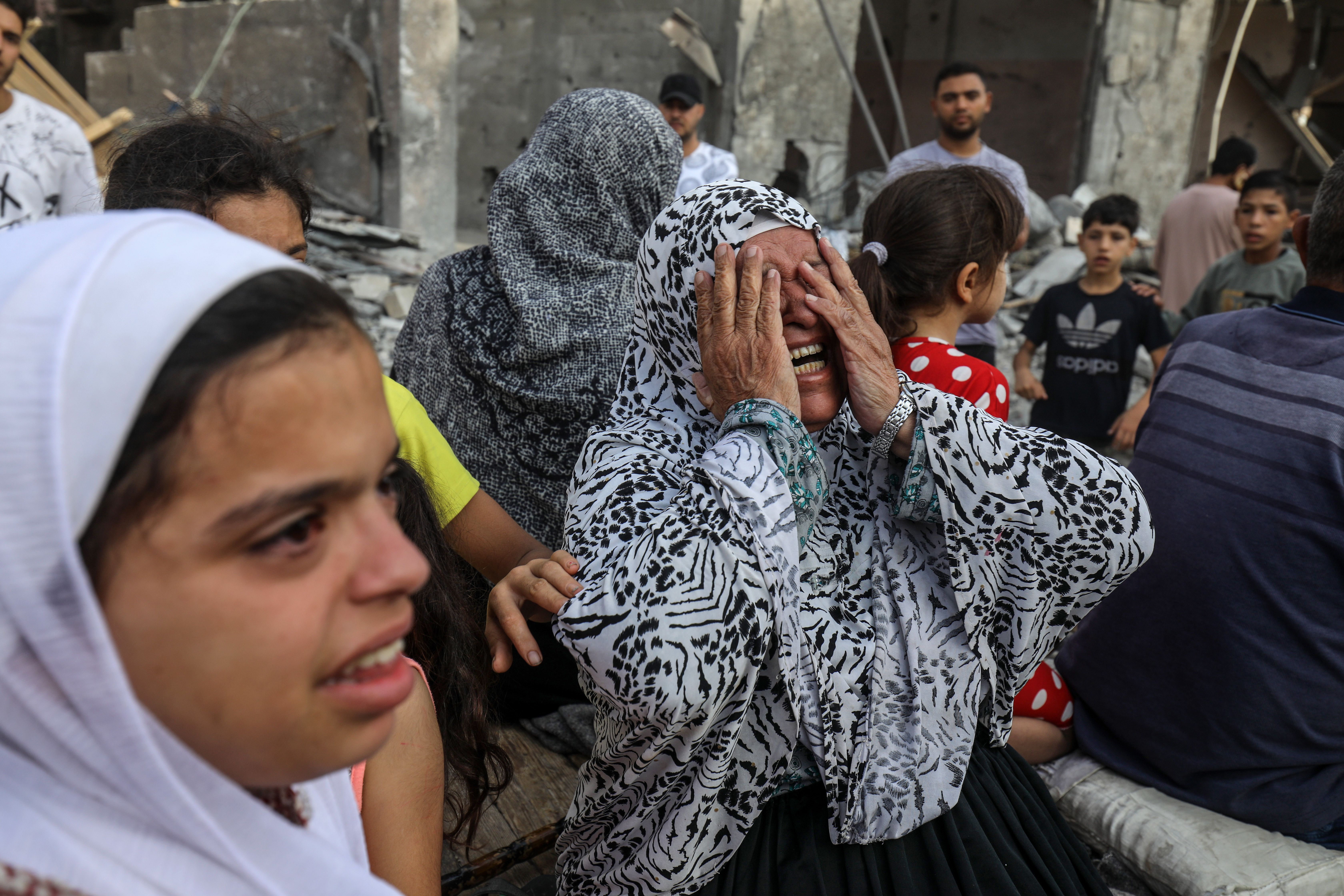 A woman reacts after Israeli fighter jets destroyed a building following the Operation Al-Aqsa Flood launched by Hamas in Rafah, Gaza on October 08, 2023. (Photo by Abed Rahim Khatib/Anadolu Agency via Getty Images)