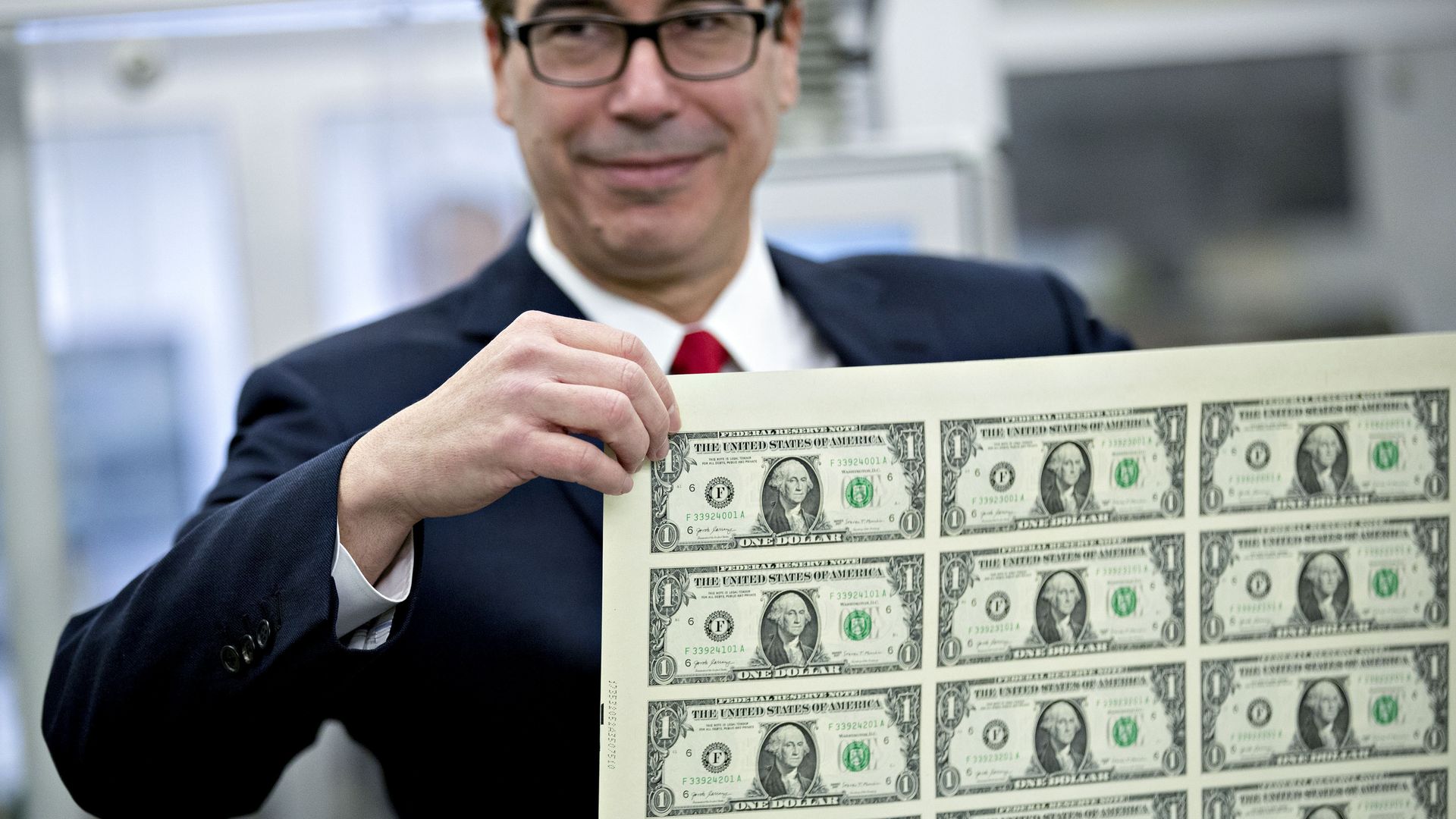 Steve Mnuchin holding dollar bills