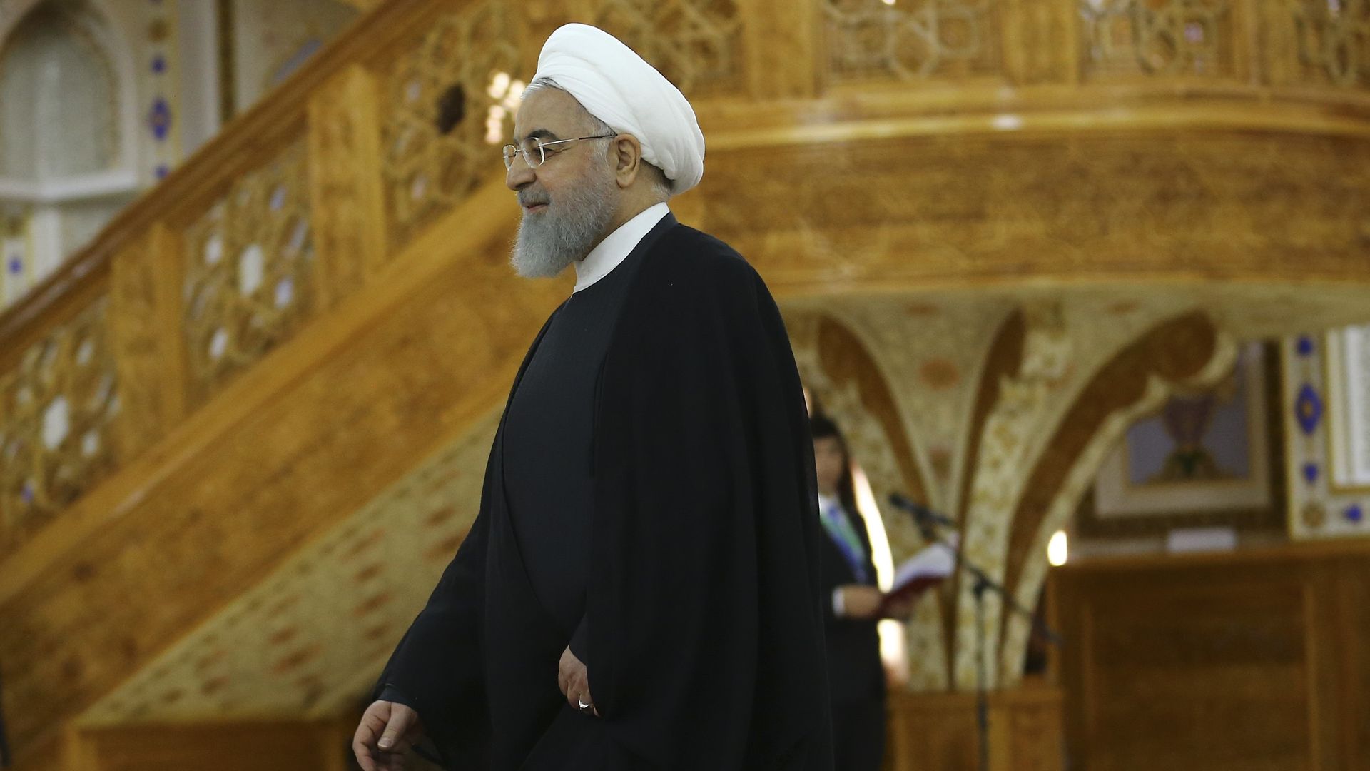 Hassan Rouhani walking through a room