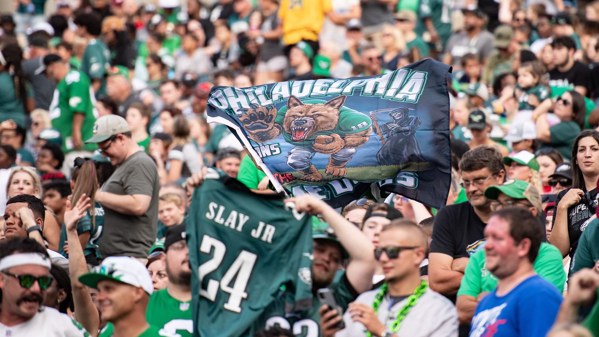 Philadelphia fans hold up a jersey of Eagles cornerback Darius Slay during training camp.