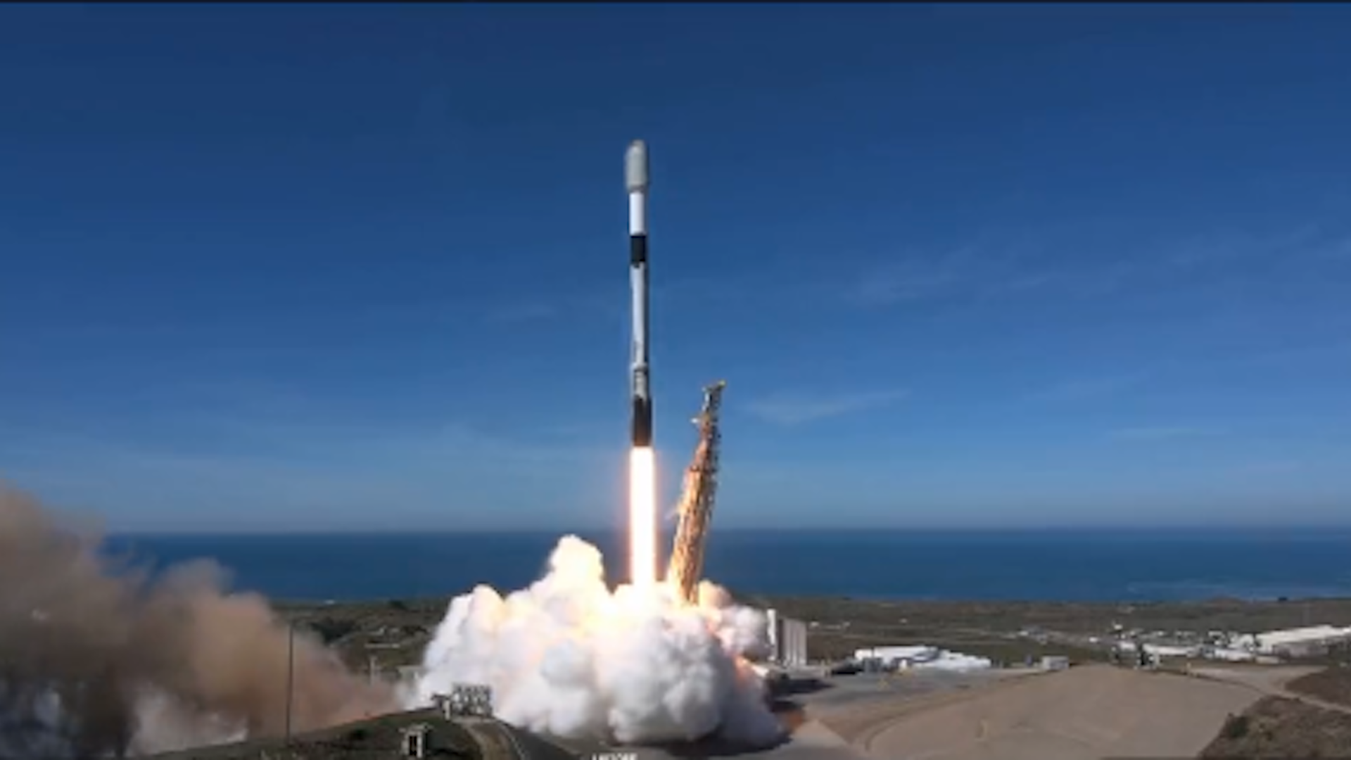 View of the launch of a SpaceX Falcon 9 Rocket on Nov. 11, showing the rocket blasting a trail of heated exhaust and white smoke from the launch tower.