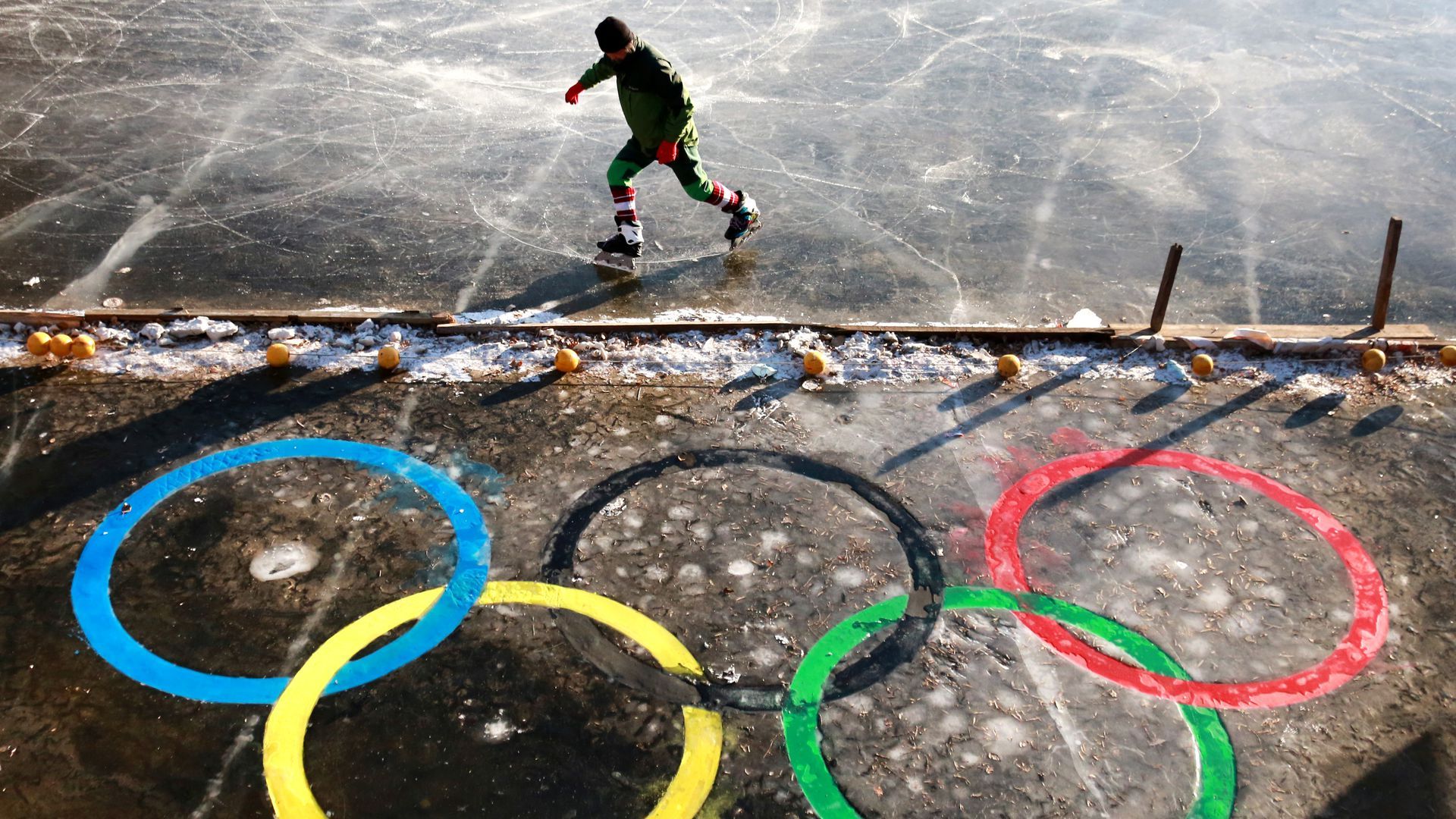 A man ice skating on an outdoor rink in Shenyang, Liaoning Province of China.