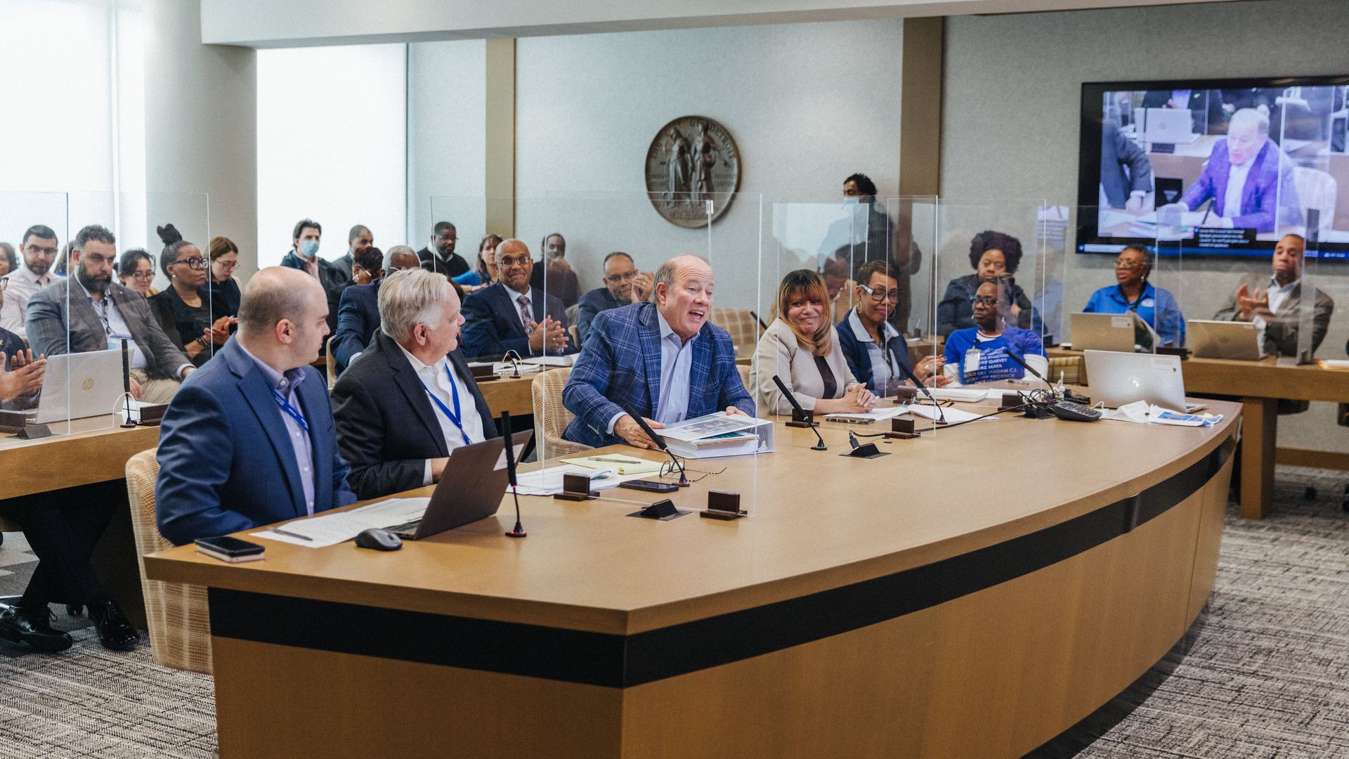 Duggan speaks in a room crowded with officials