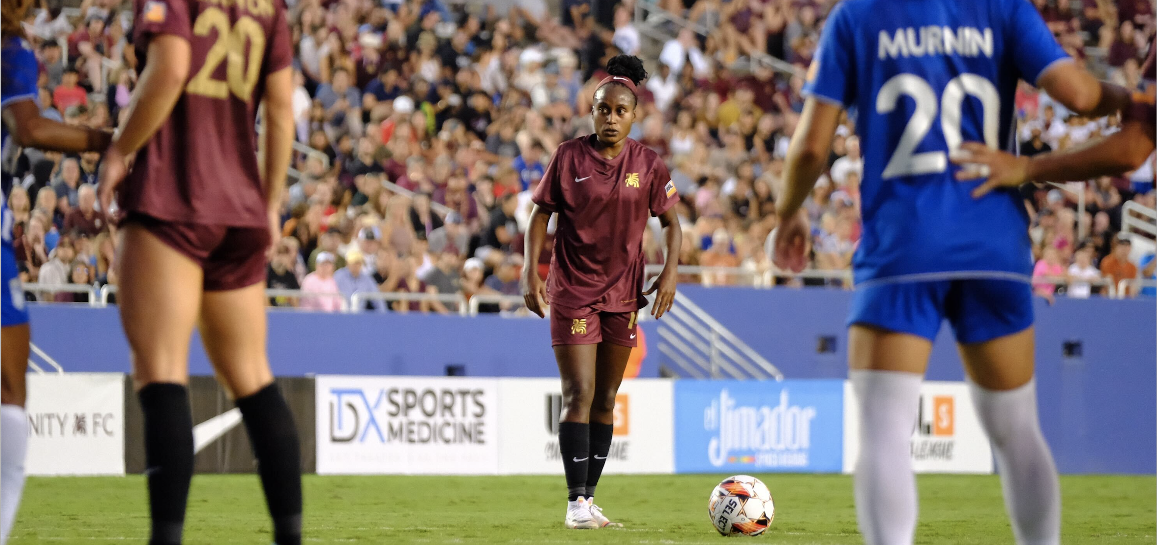 A soccer player gets ready to kick the ball