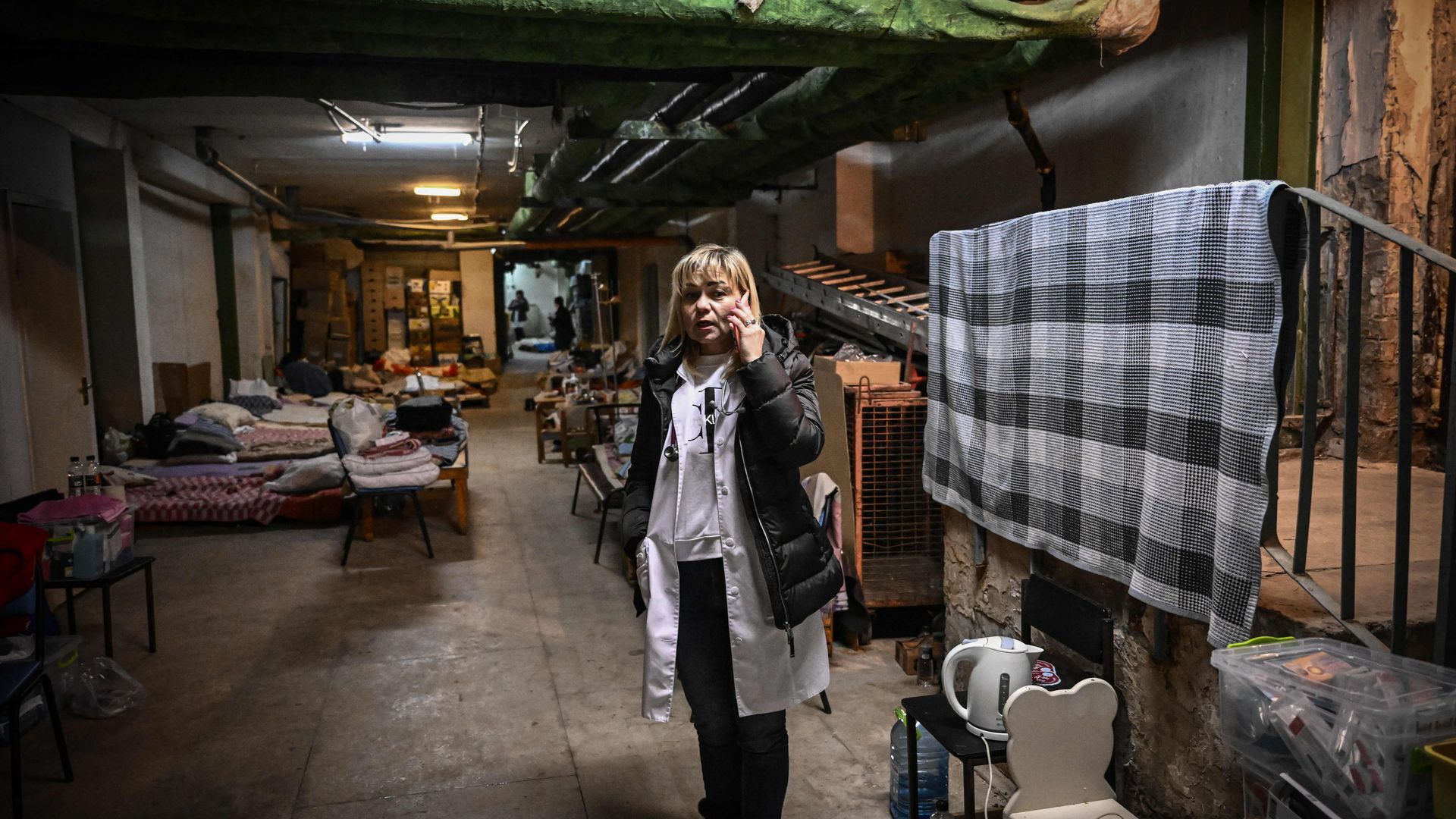 Picture of a person speaking on the phone in a bomb shelter