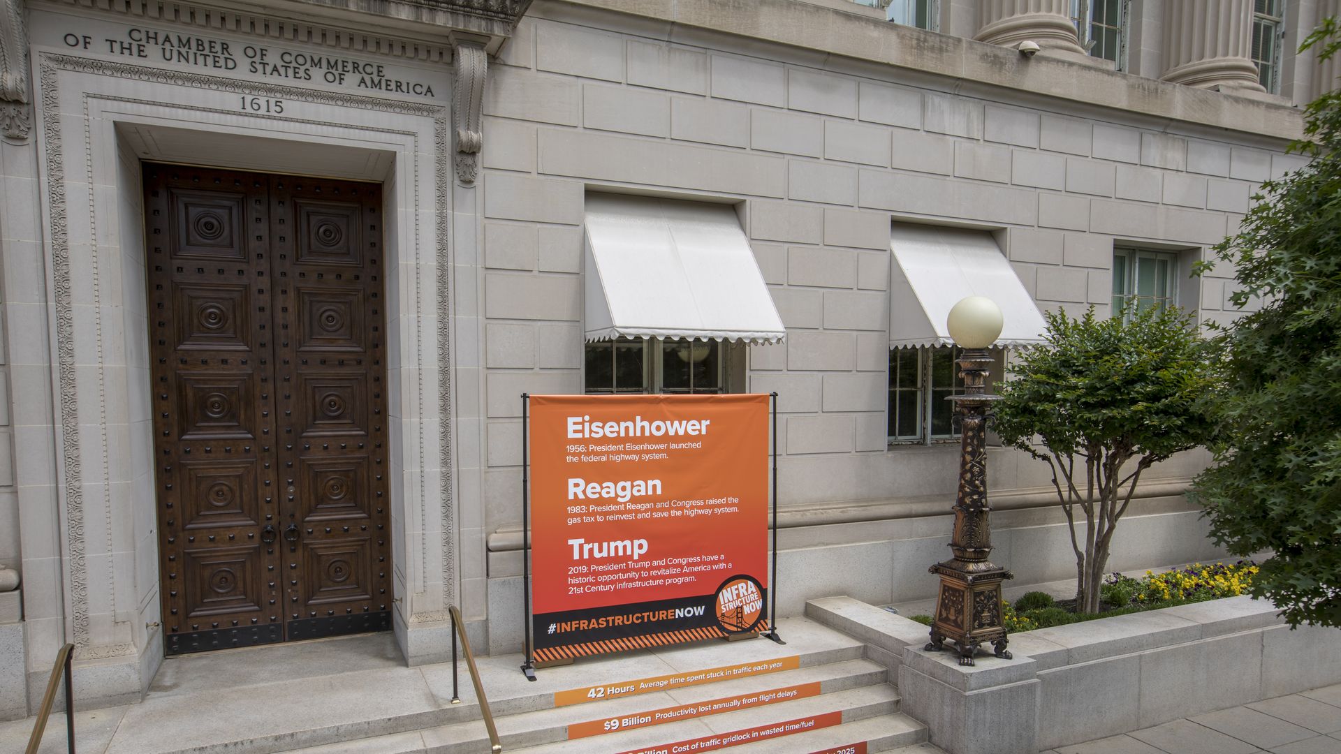 A sign comparing Trump to Reagan and Eisenhower, on the steps of the Chamber of Commerce building in D.C.