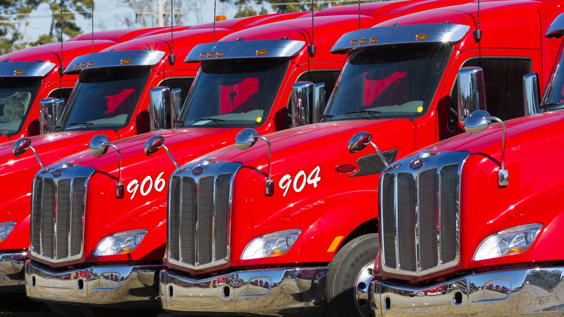 Red engines and cabs of big trucks. 