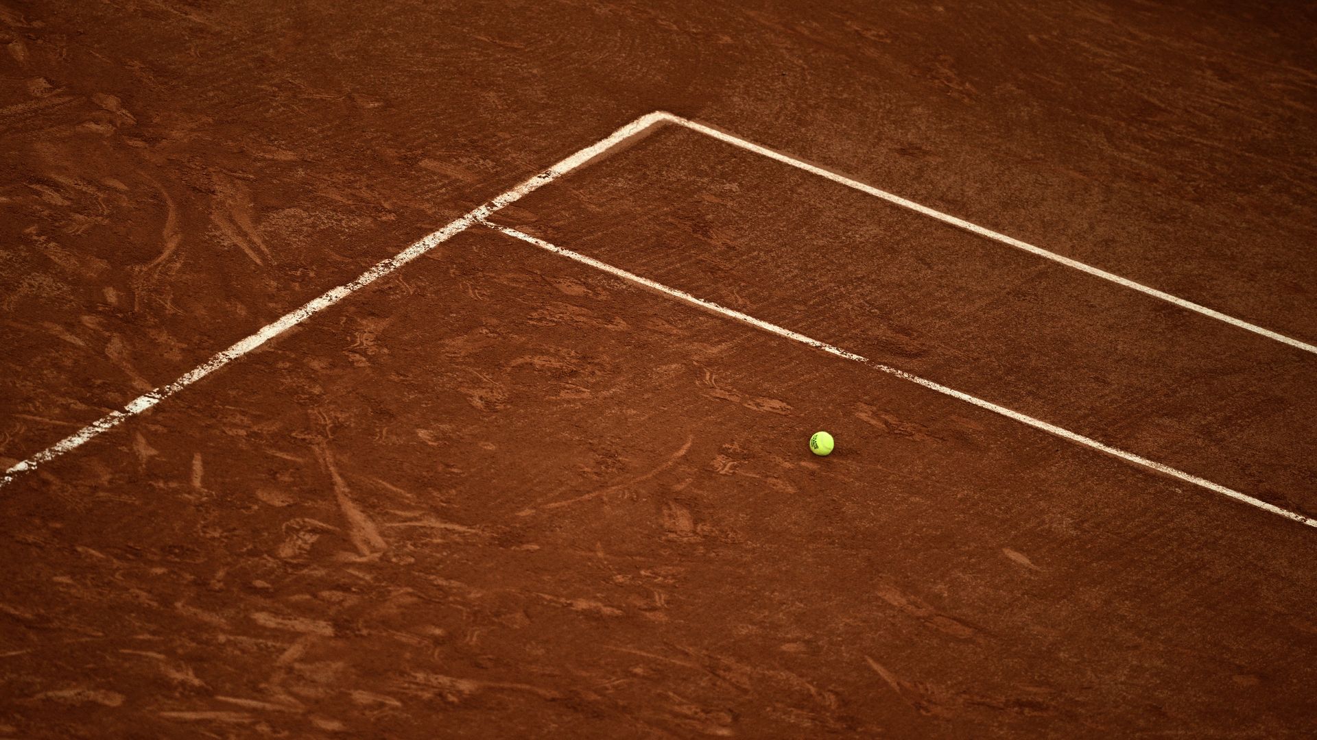 An official Roland-Garros tennis ball sits on the clay on day 1 of the French Open tennis tournament on Court Suzanne-Lenglen at the Roland-Garros Complex in Paris on May 24, 2026. (Photo by JULIEN DE ROSA / AFP via Getty Images)

