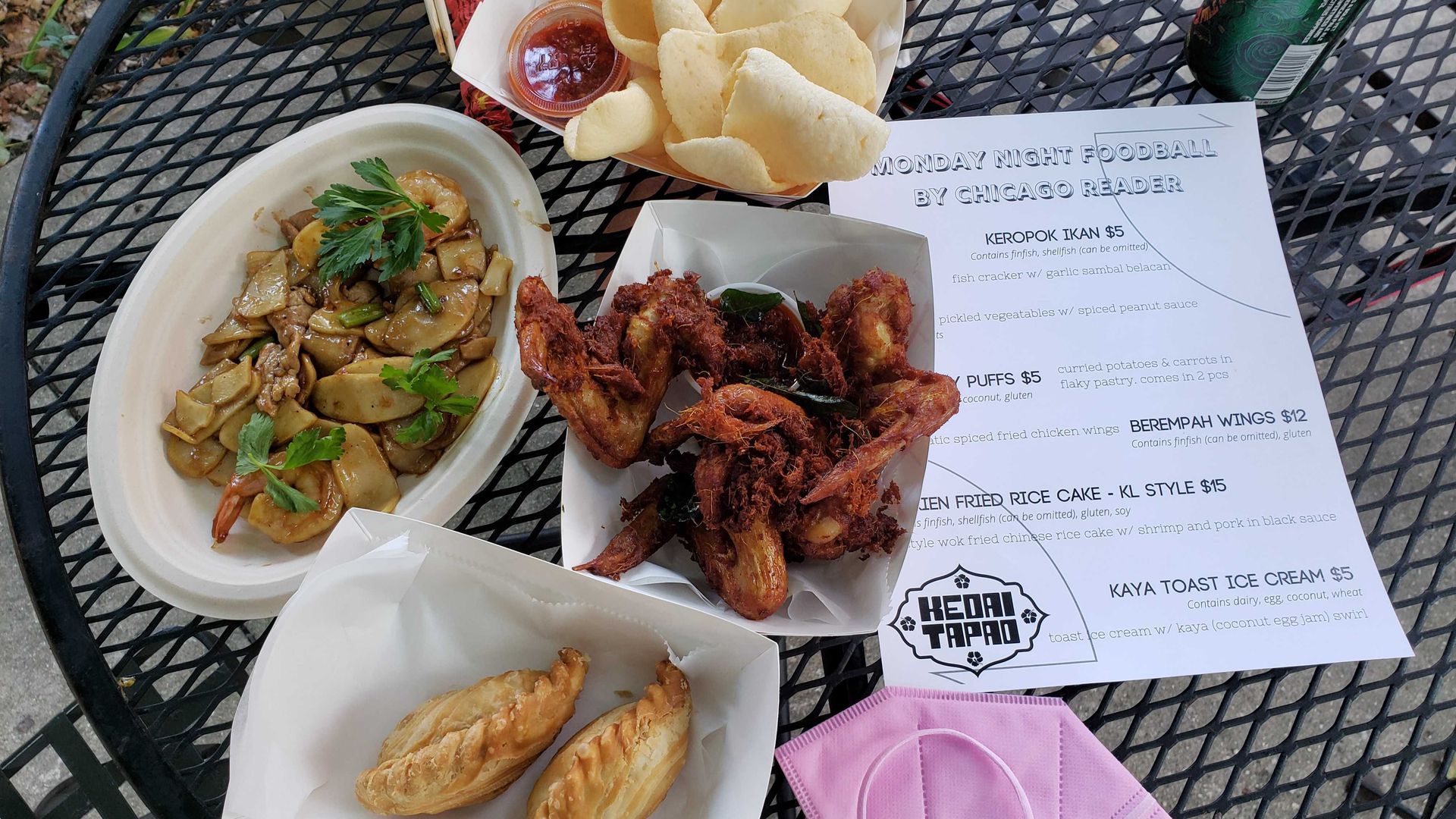 An assortment of food including Malaysian fish crackers, aromatic chicken wings, curry puffs and Hokkien rice cakes on a table.