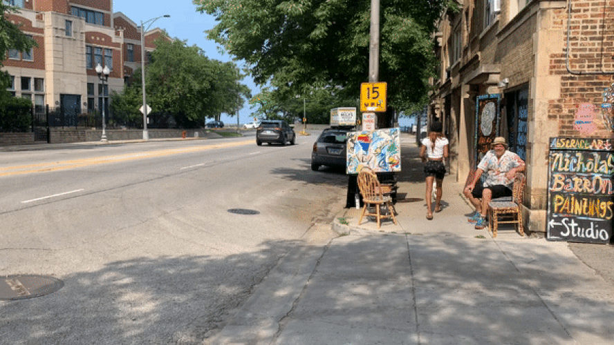 GIF of an artist painting on a sidewalk
