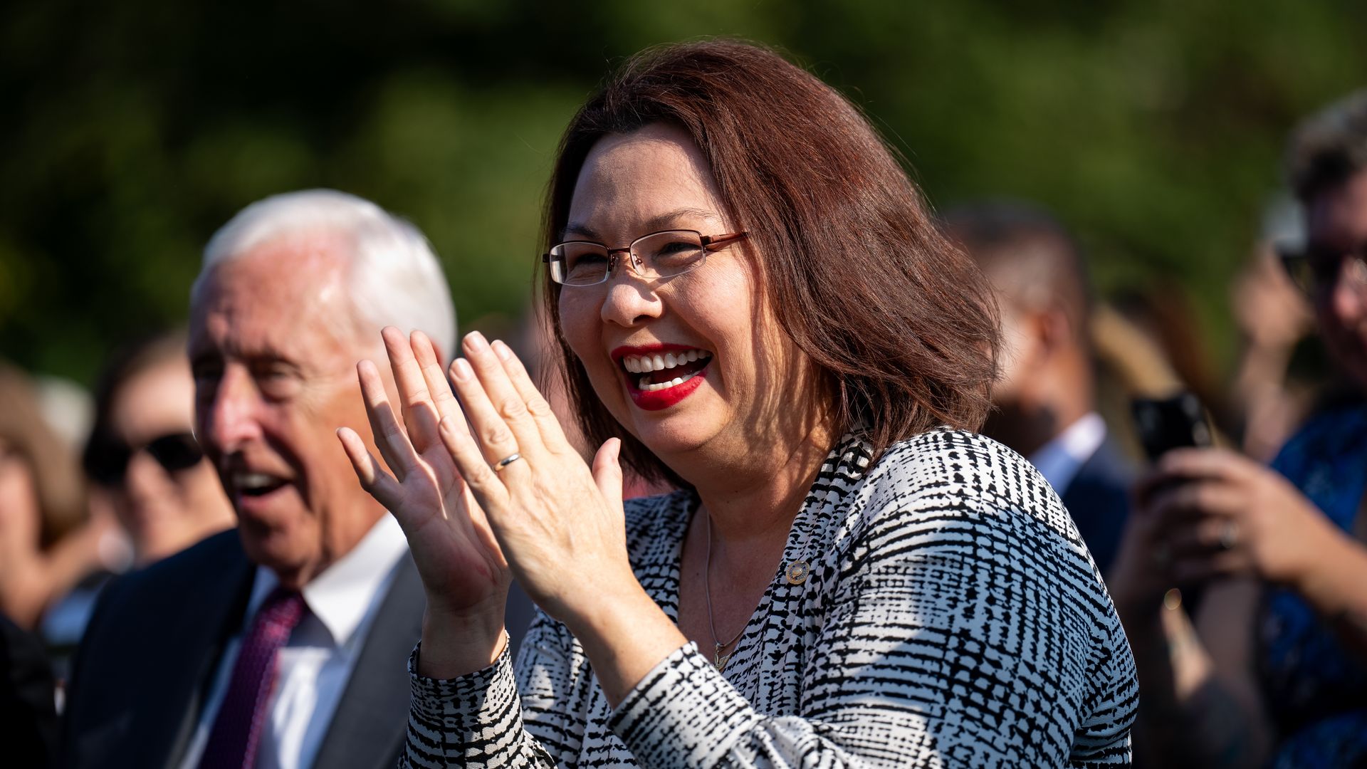 Sen. Tammy Duckworth (D-Ill.) claps and smiles at a White House event.