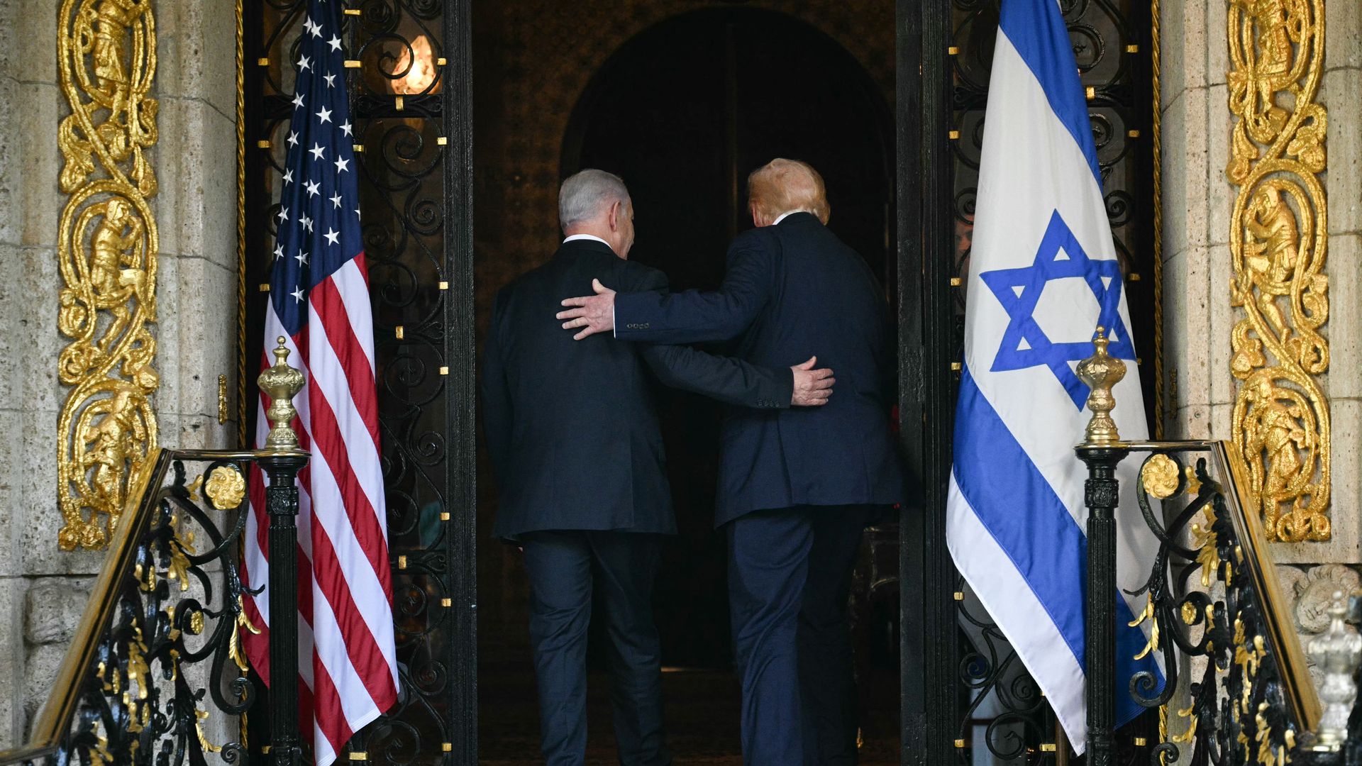 men walking with arms around each other