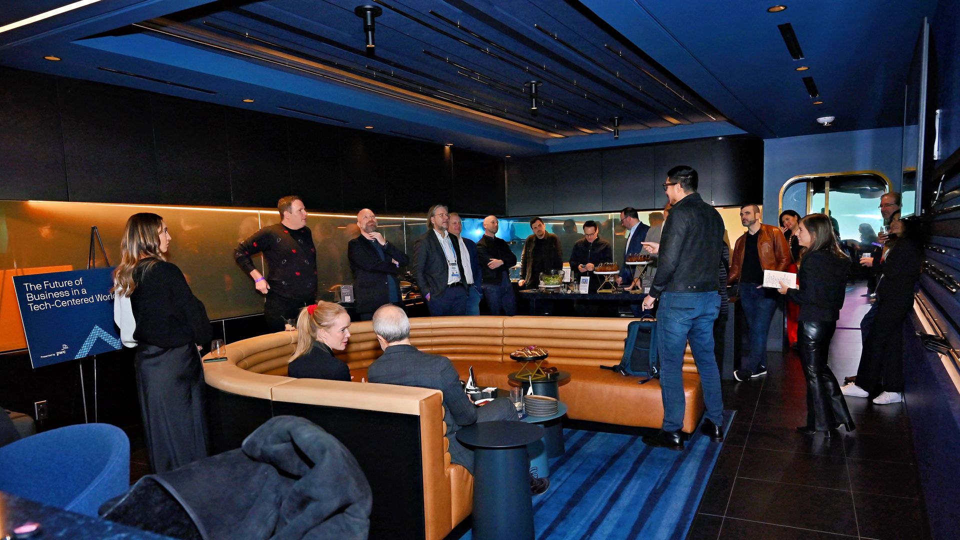 Attendees gathered in a sleek and intimate event venue space for an evening of networking and conversation. 