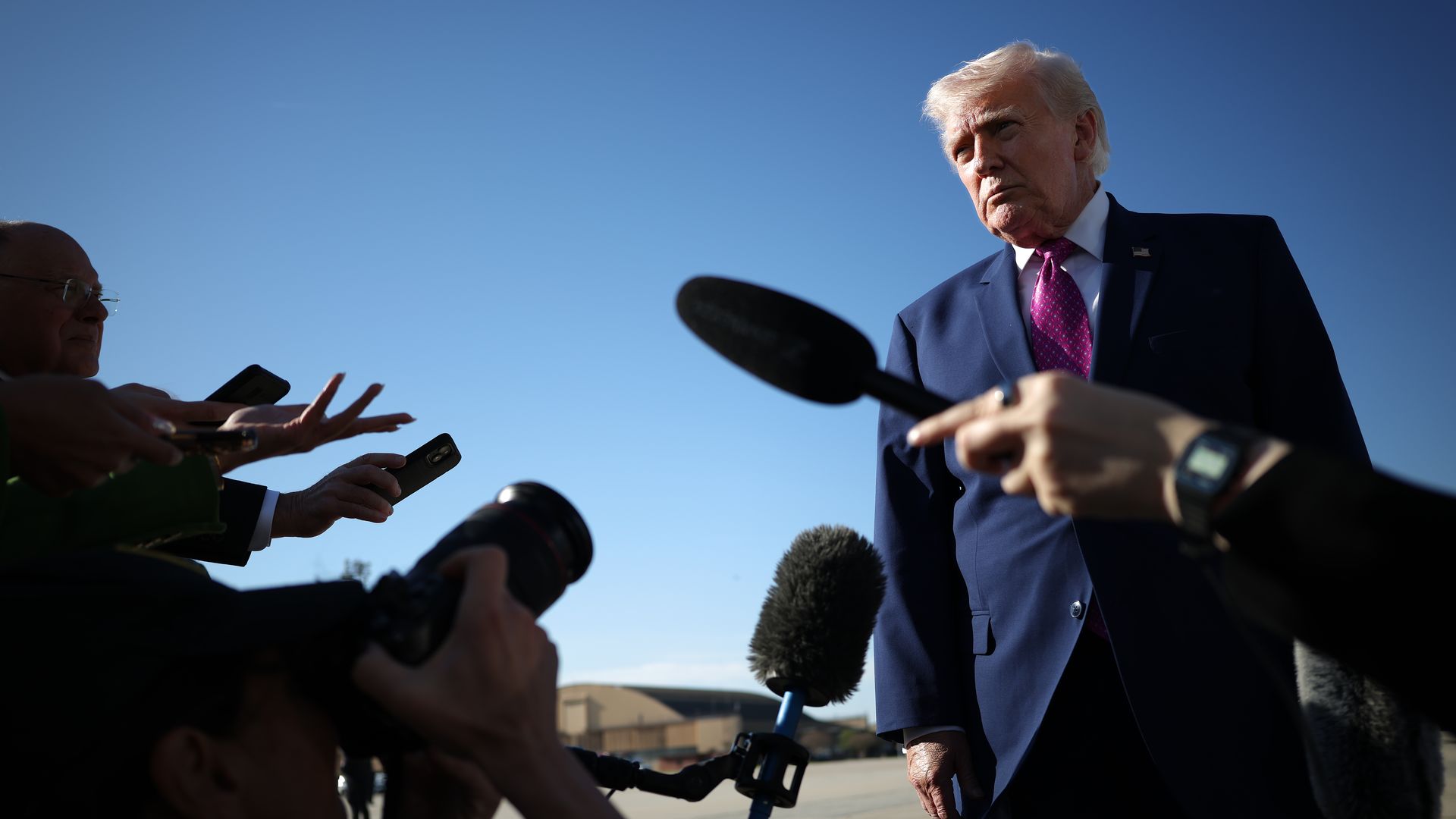 President Donald Trump talks to reporters on the tarmac before boarding Air Force One at Joint Base Andrews in Maryland.