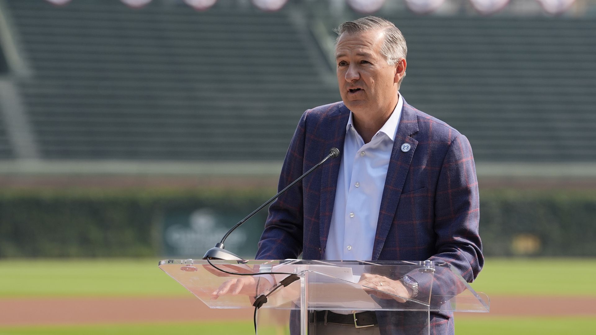 Photo of a man behind a podium speaking into a microphone. 