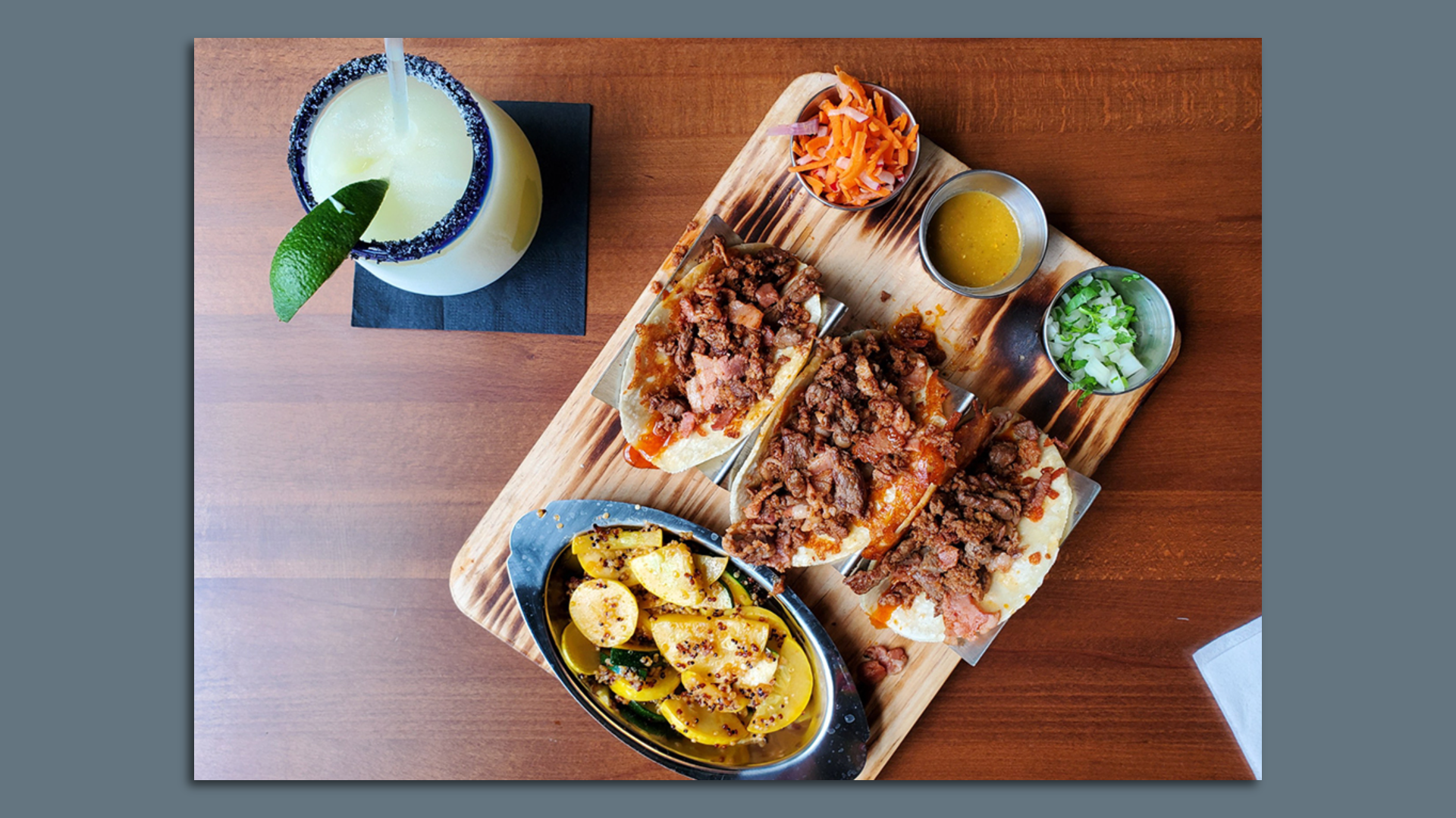 A plate of tacos and a drink.