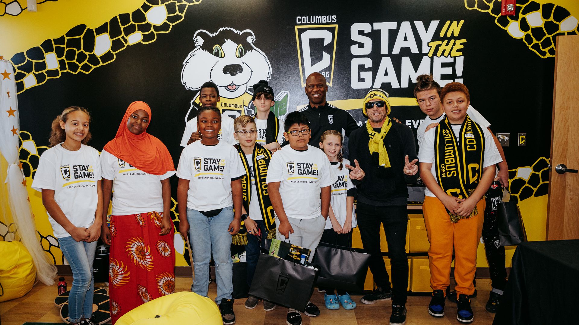School children pose with Crew representatives