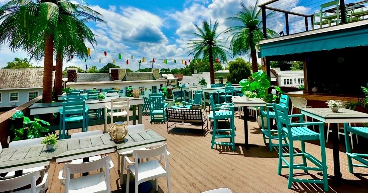 a beachy rooftop bar with turquoise-y chairs