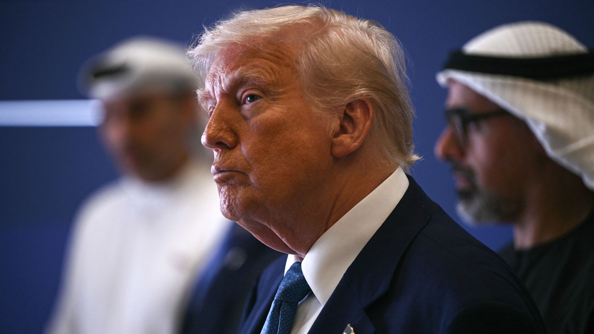 US President Donald Trump (C) and Abu Dhabi's Crown Prince Sheikh Khaled (R) attend a business forum in Abu Dhabi on May 16, 2025.
