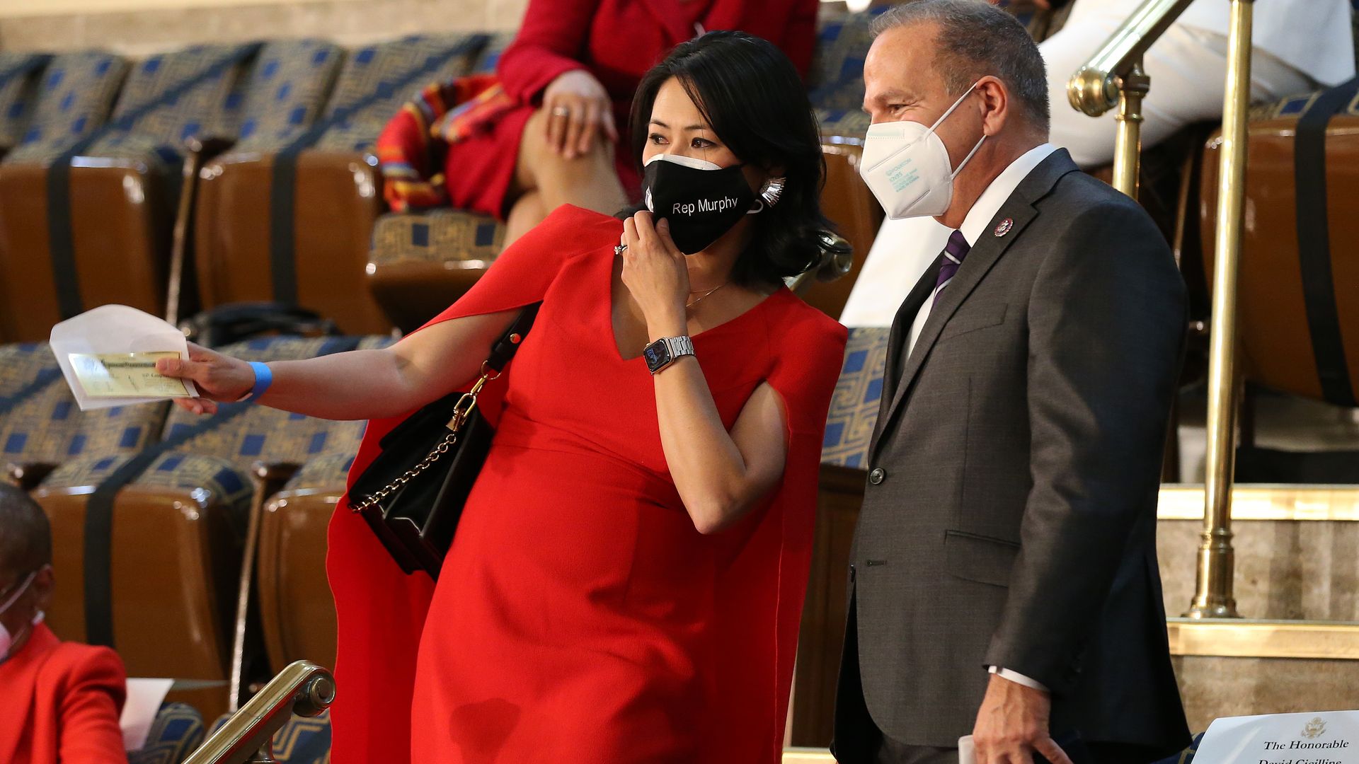 Stephanie Murphy gestures with an envelope