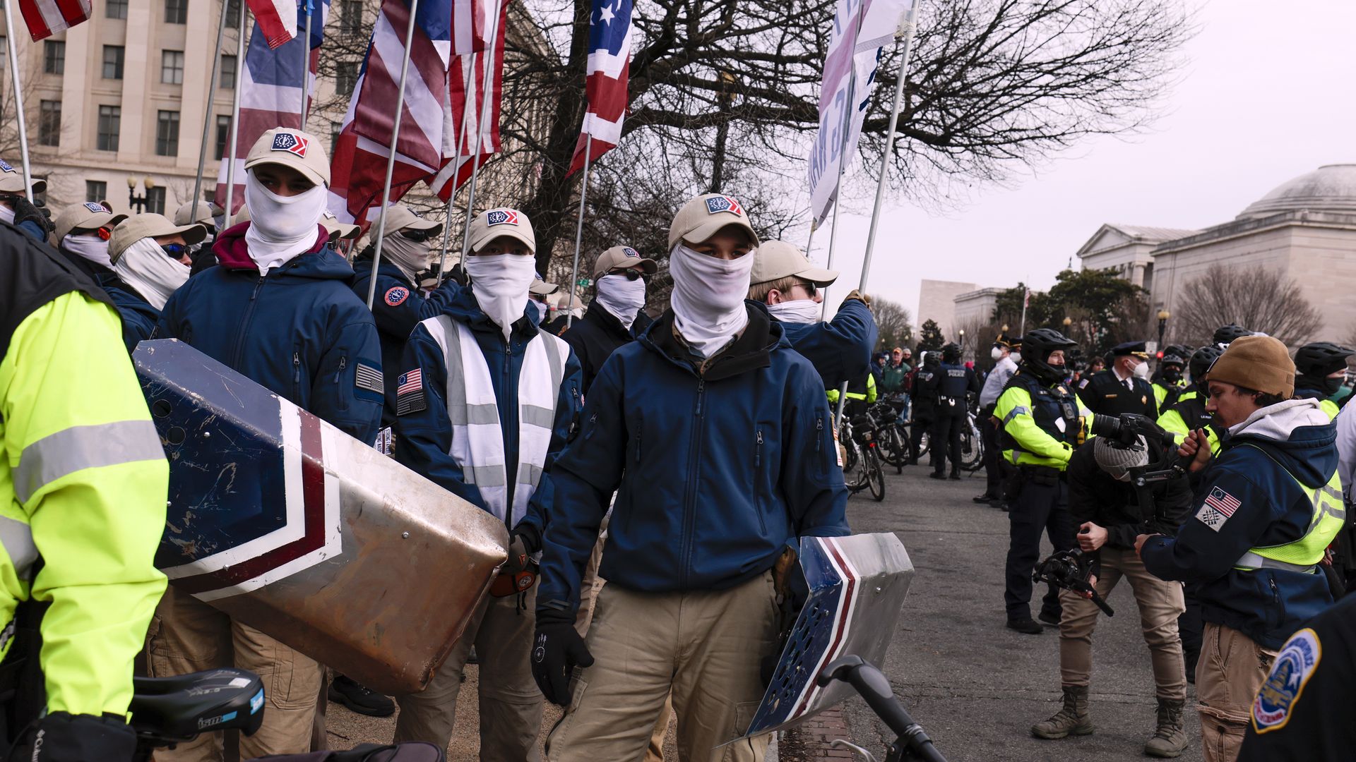 Police officers surround members of the Patriot Front 