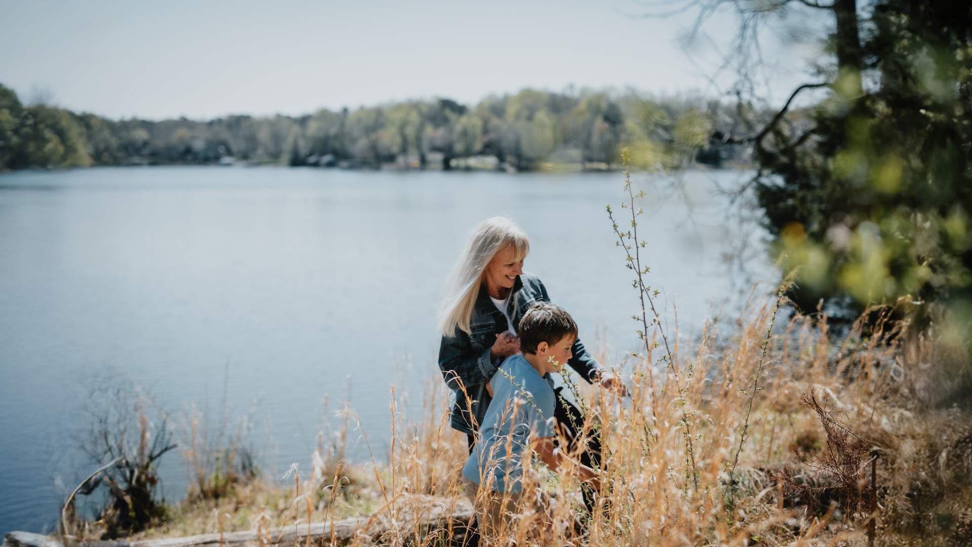 Two people stand by the water.