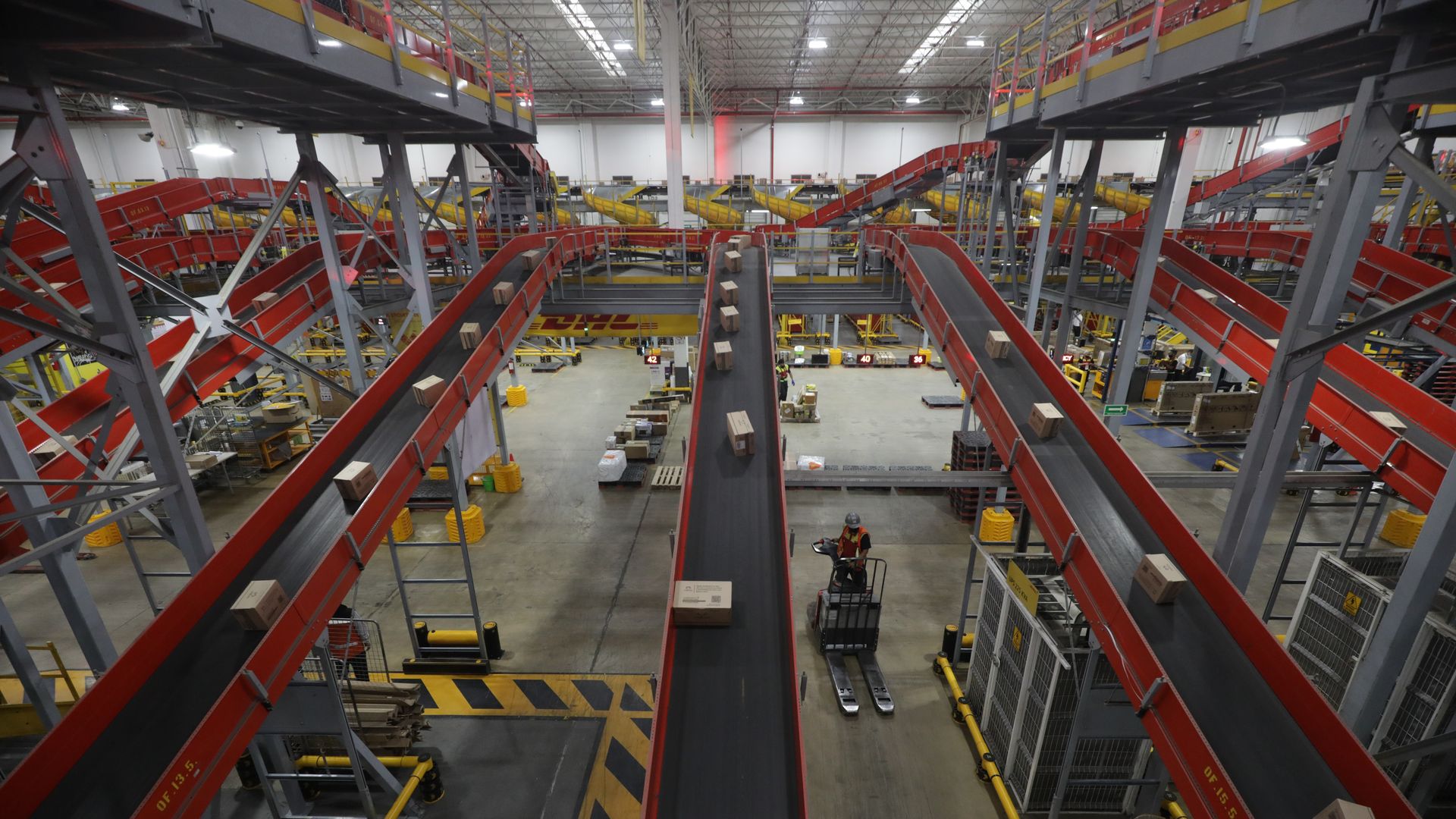 A worker drives a forklift at a DHL distribution center in Mexico on March 12, 2025.