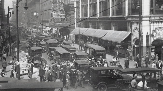 GIF of an old photo showing a restaurant and a theater mixed with a new photo of the same location.