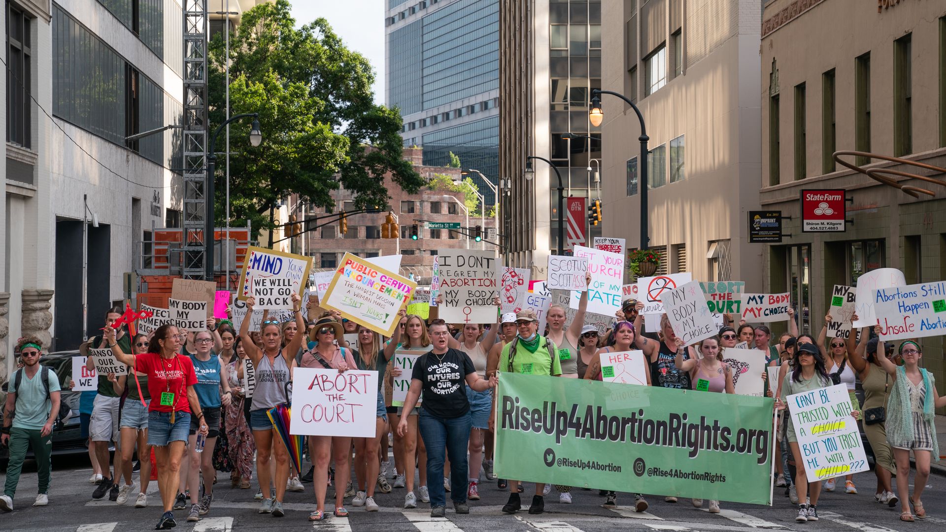 Protesters walk in downtown Atlanta in opposition to the U.S. Supreme Court decision that overturned Roe v. Wade